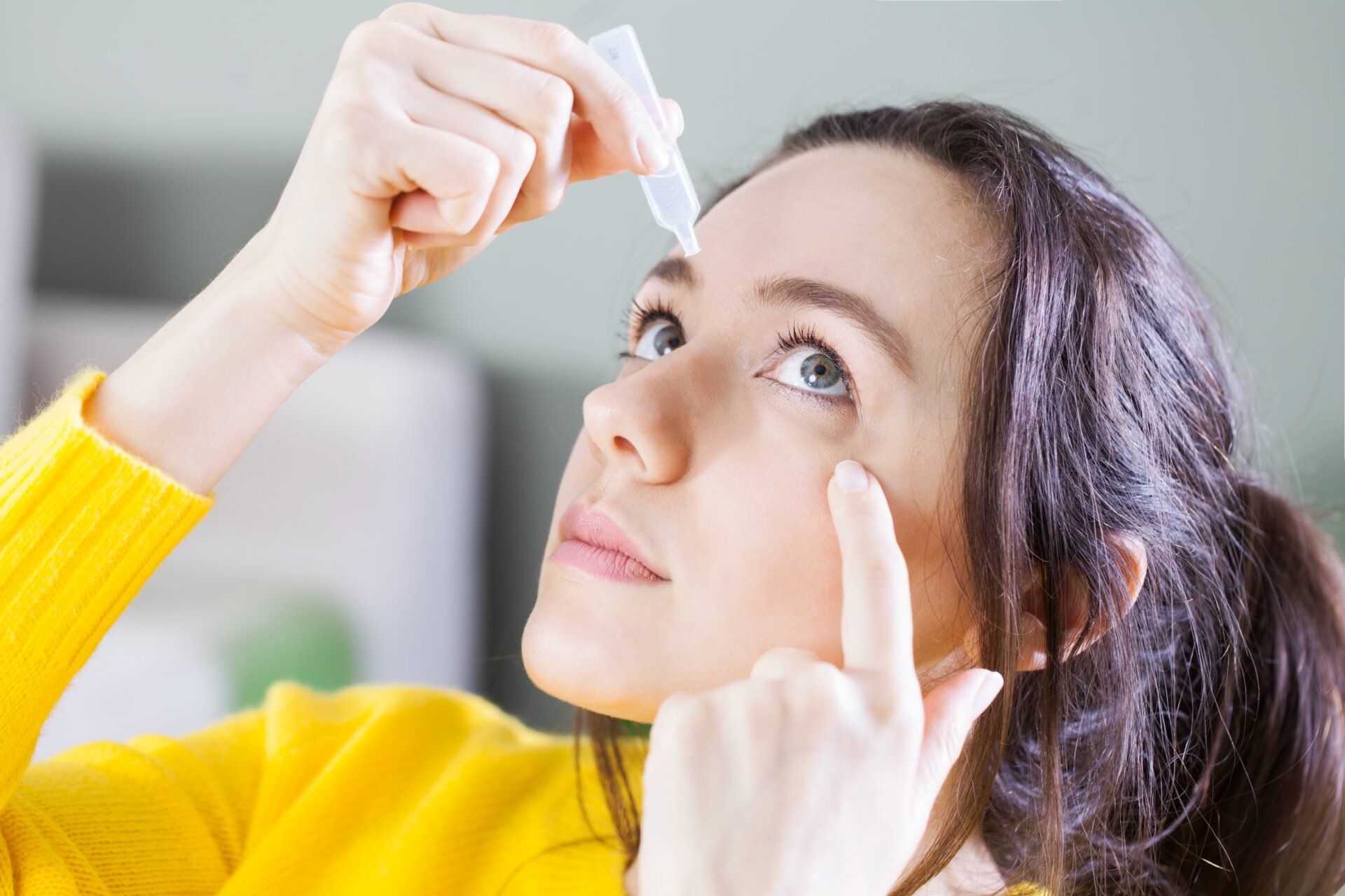 Young woman uses eye drops for eye treatment. redness, dry eyes, allergy and eye itching