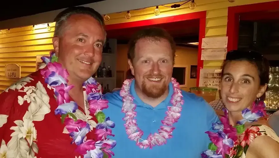 A group of people are dancing with their arms in the air