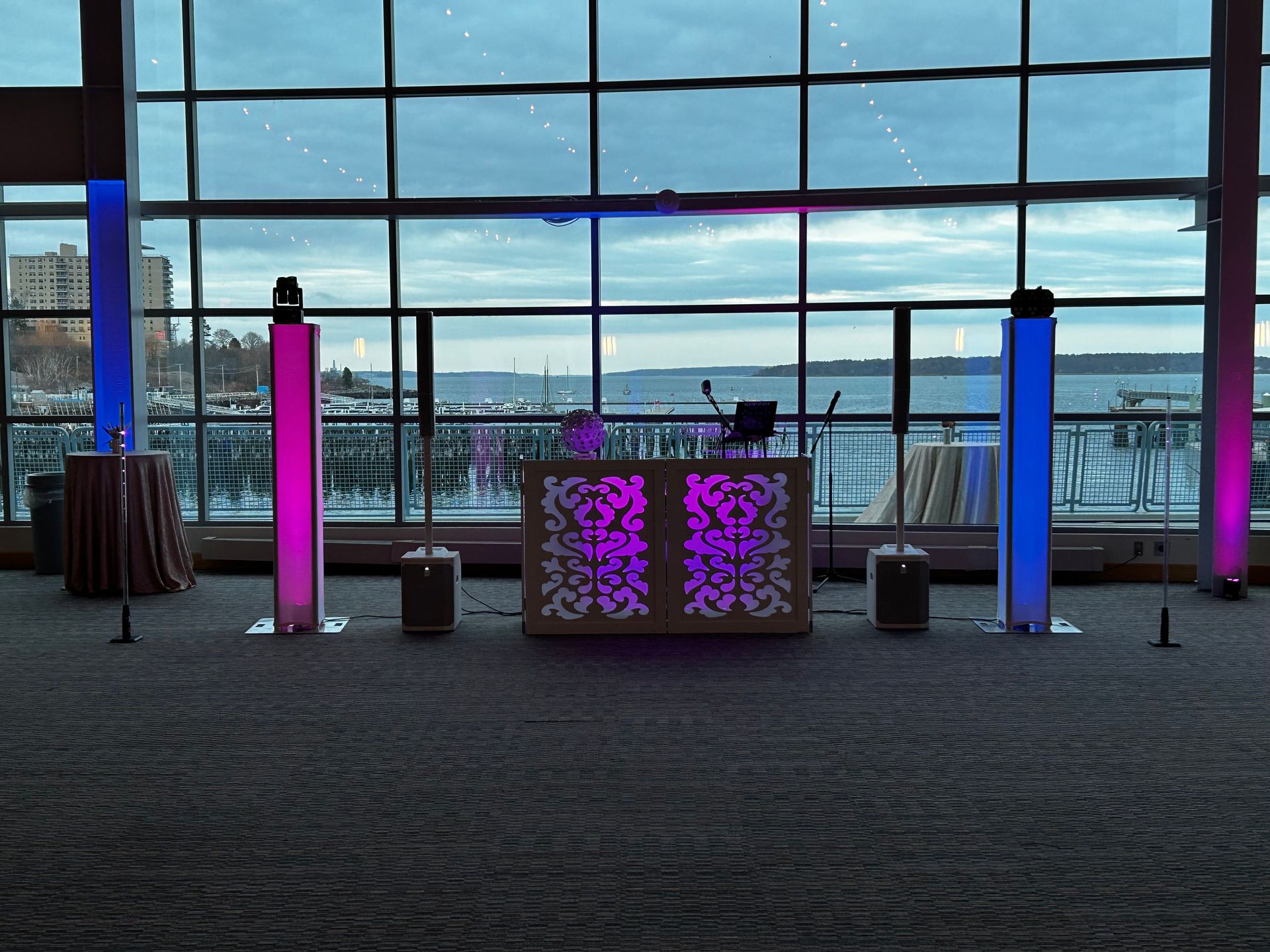 A large room with a large window and a dj booth