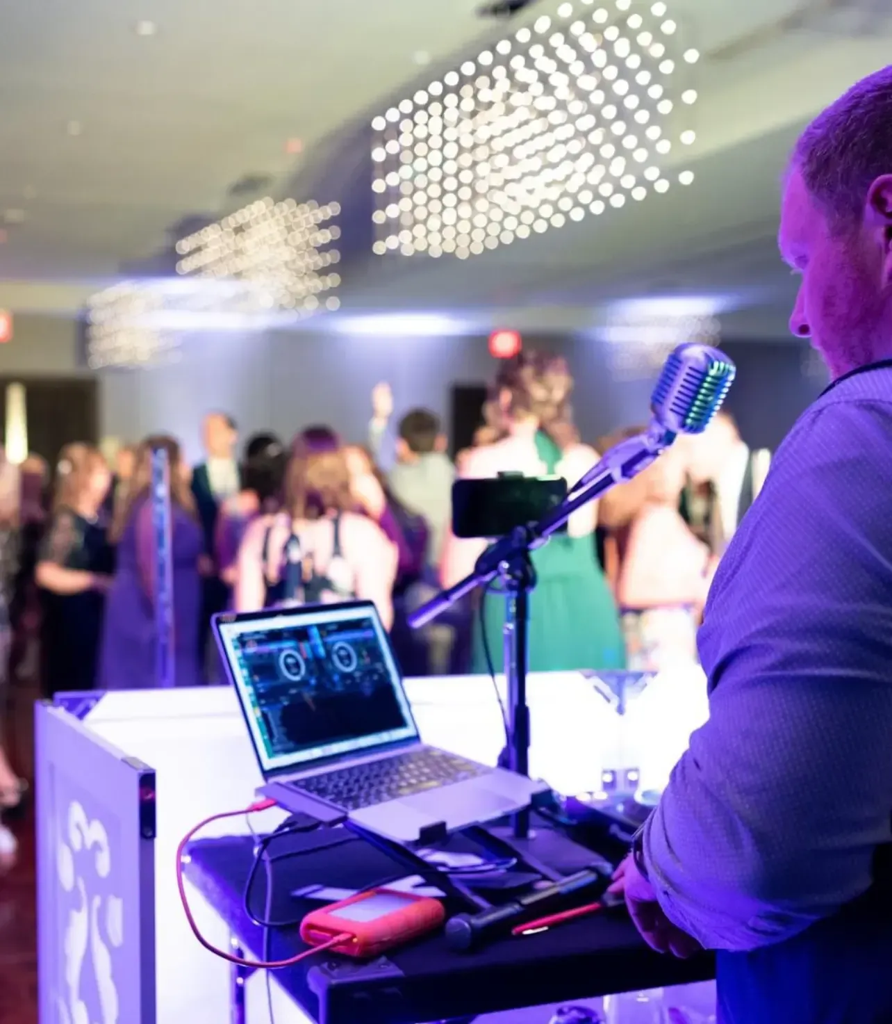 A man stands at a podium with a laptop and a microphone