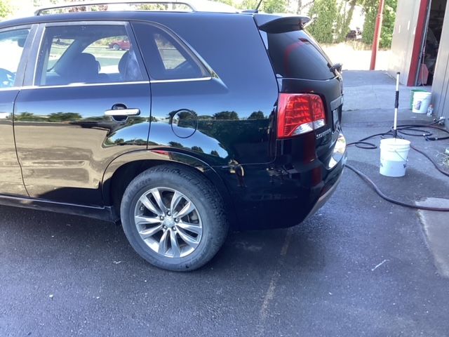A black suv is parked in a parking lot