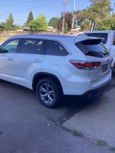 A white suv is parked on the side of the road