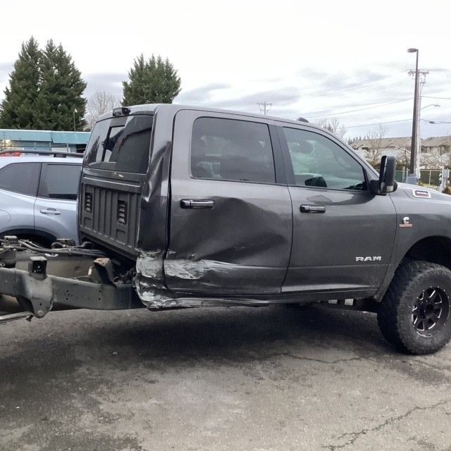 A black truck with a dent.