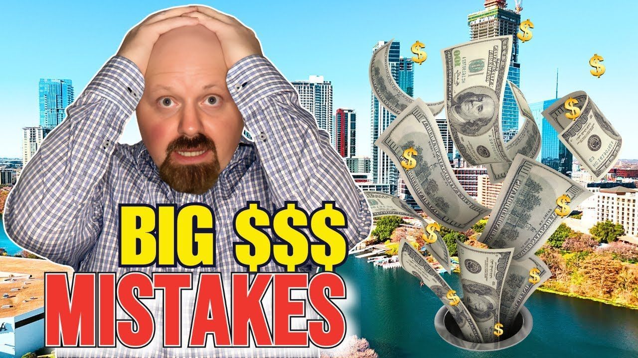 A man is holding his head in front of a pile of money.