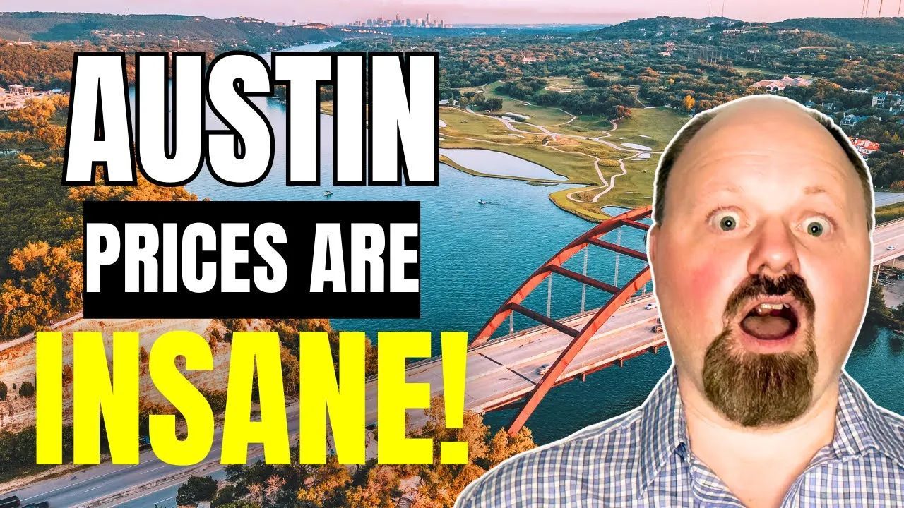 A bald man with a beard is standing in front of a bridge in austin.