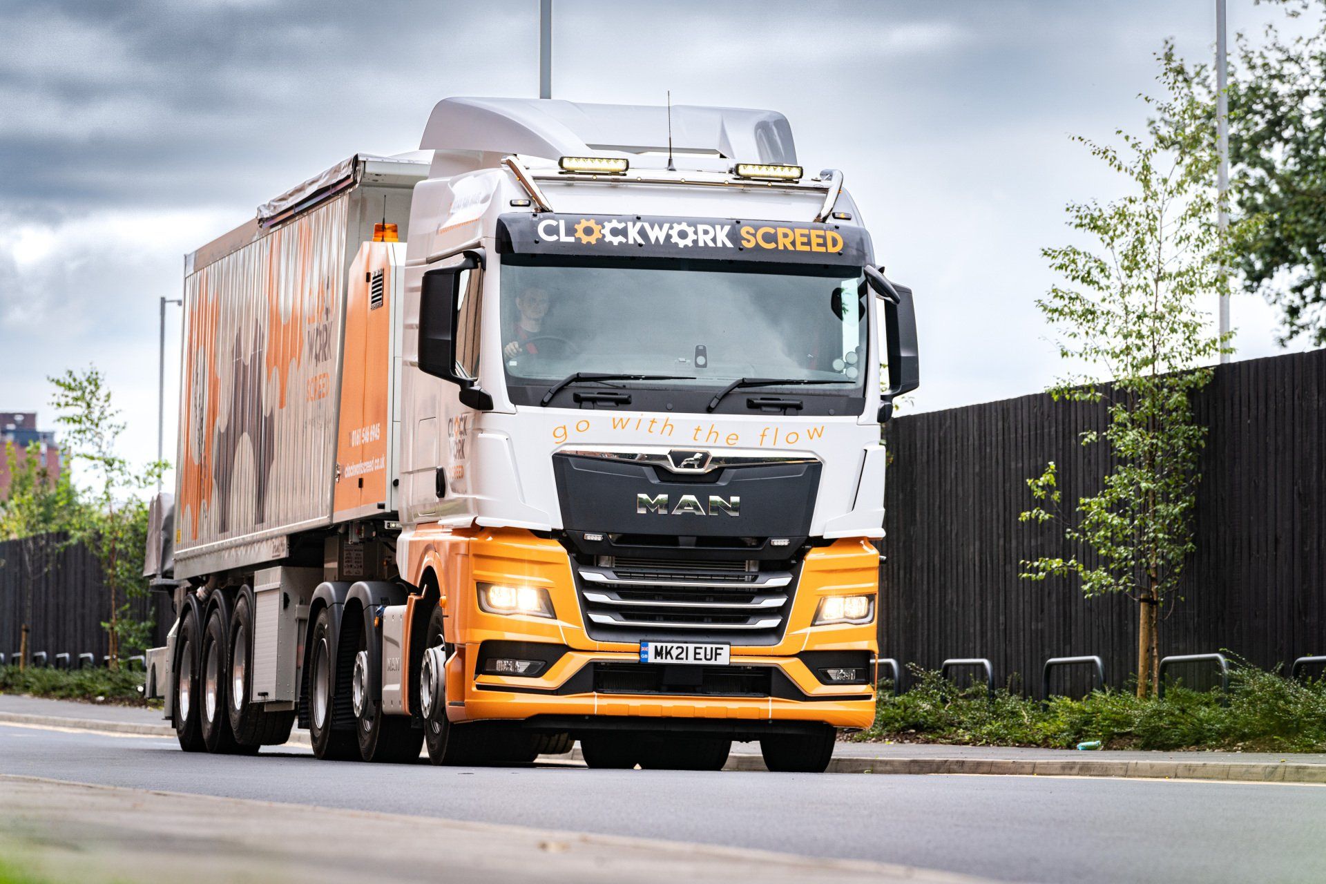 worker is trowelling a low VOC urethane adhesive onto a concrete slab