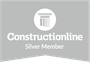 A construction online silver member logo on a gray background