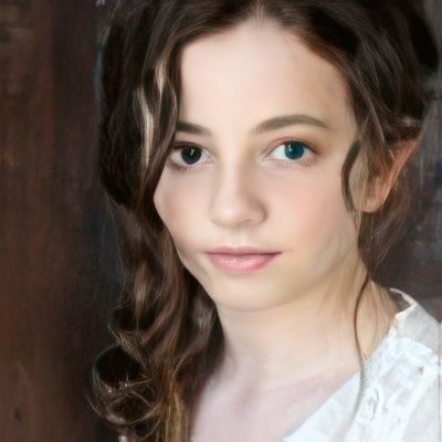 A close up of a woman 's face with a white shirt on