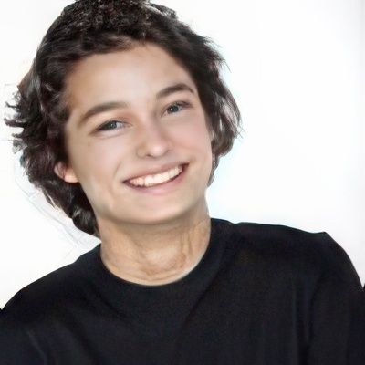 A young man wearing a black shirt is smiling for the camera