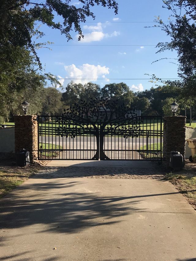 A metal gate with a tree design on it