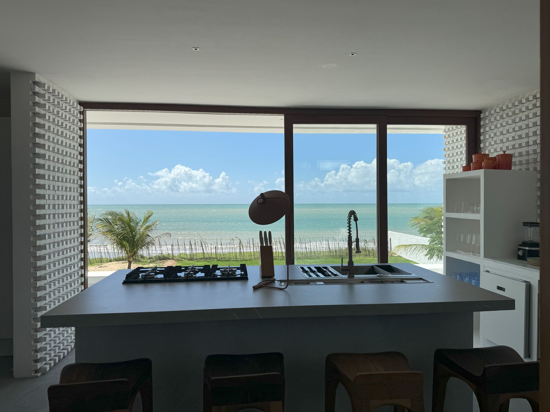 Uma cozinha com uma grande ilha e vista para o oceano.