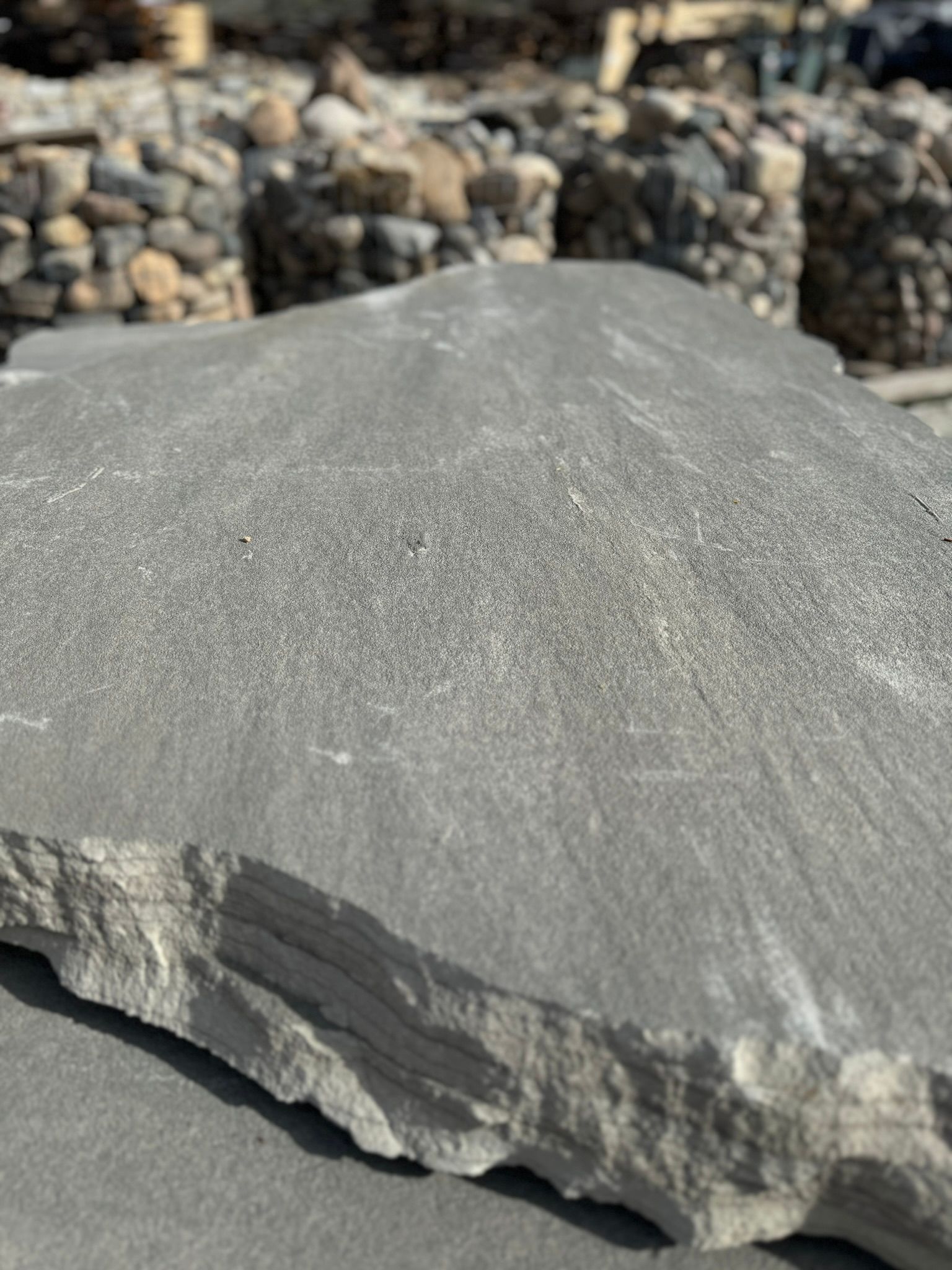 A large piece of rock is sitting on top of a pile of rocks.