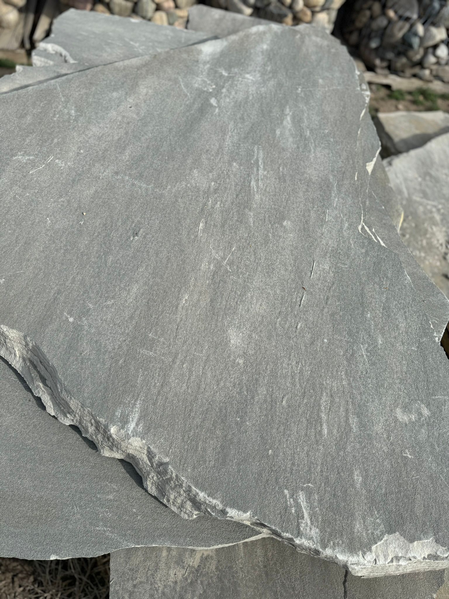 A large piece of rock is sitting on top of a pile of rocks.