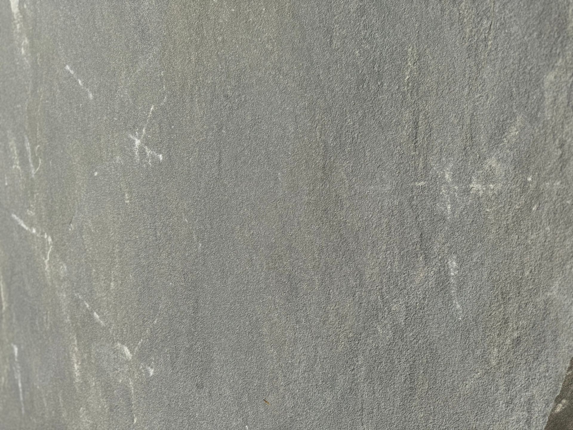 A close up of a gray tile with a grainy texture.