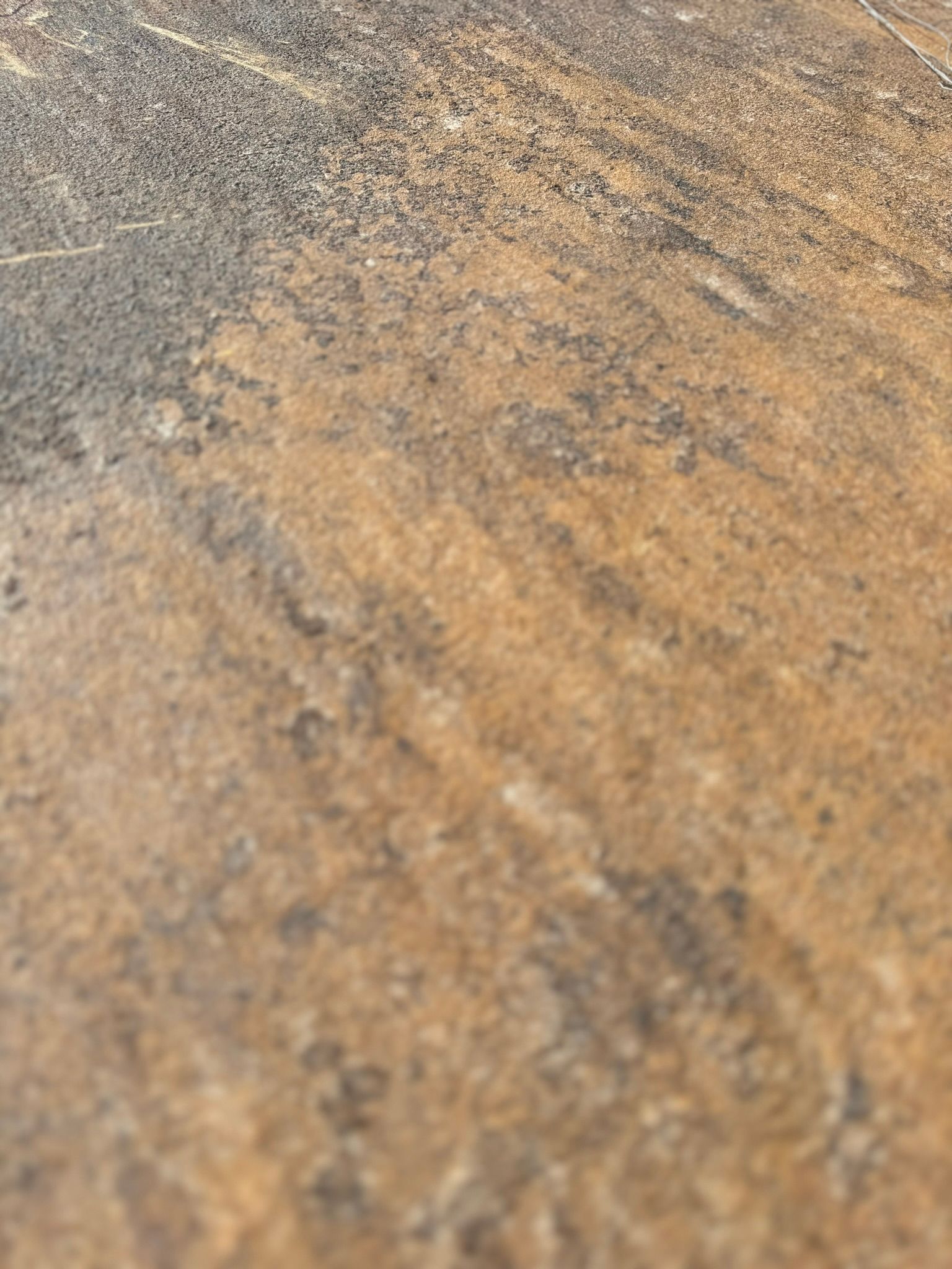 A close up of a brown and black tile floor.