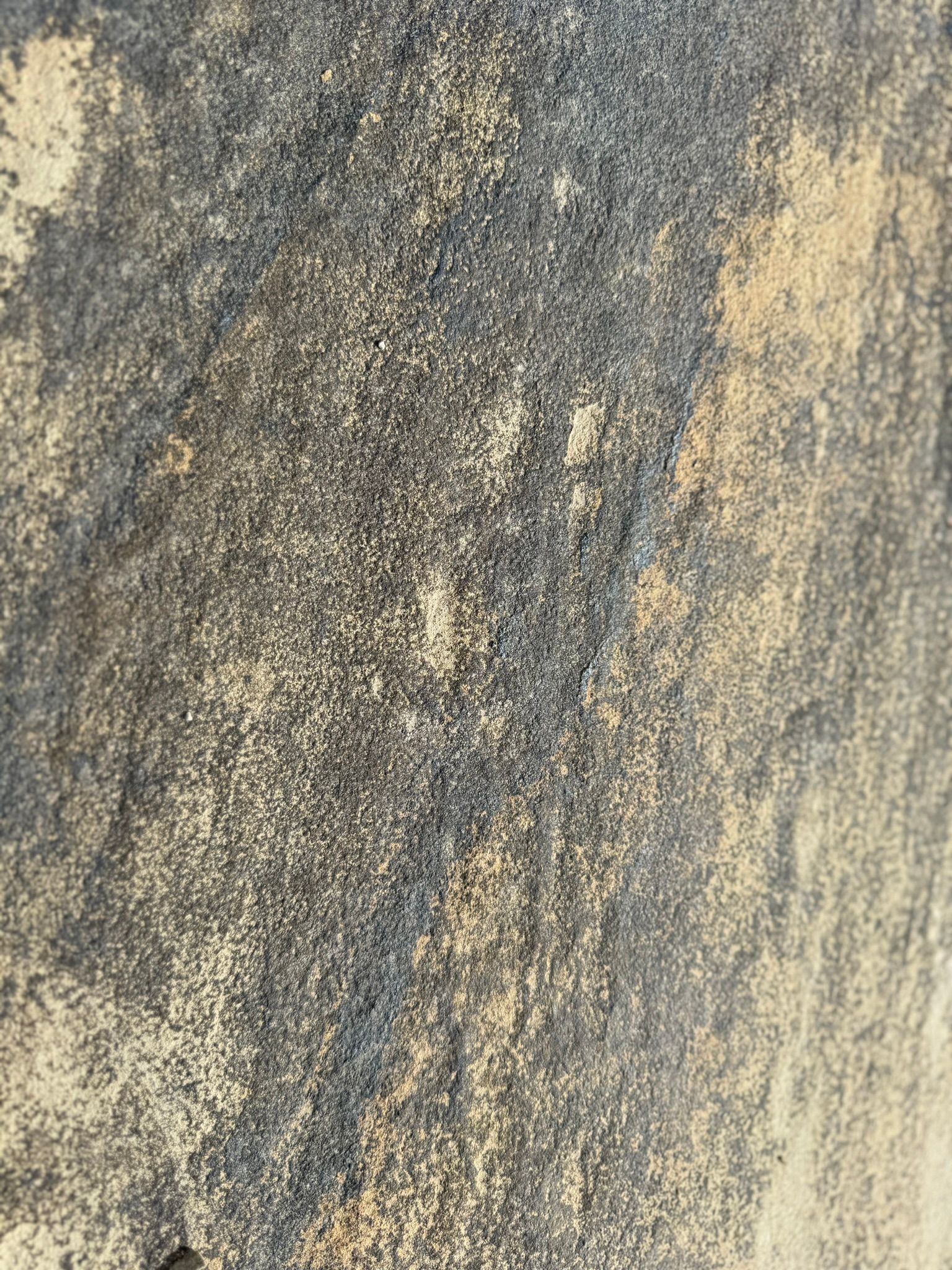 A close up of a concrete surface with a lot of small stones on it.