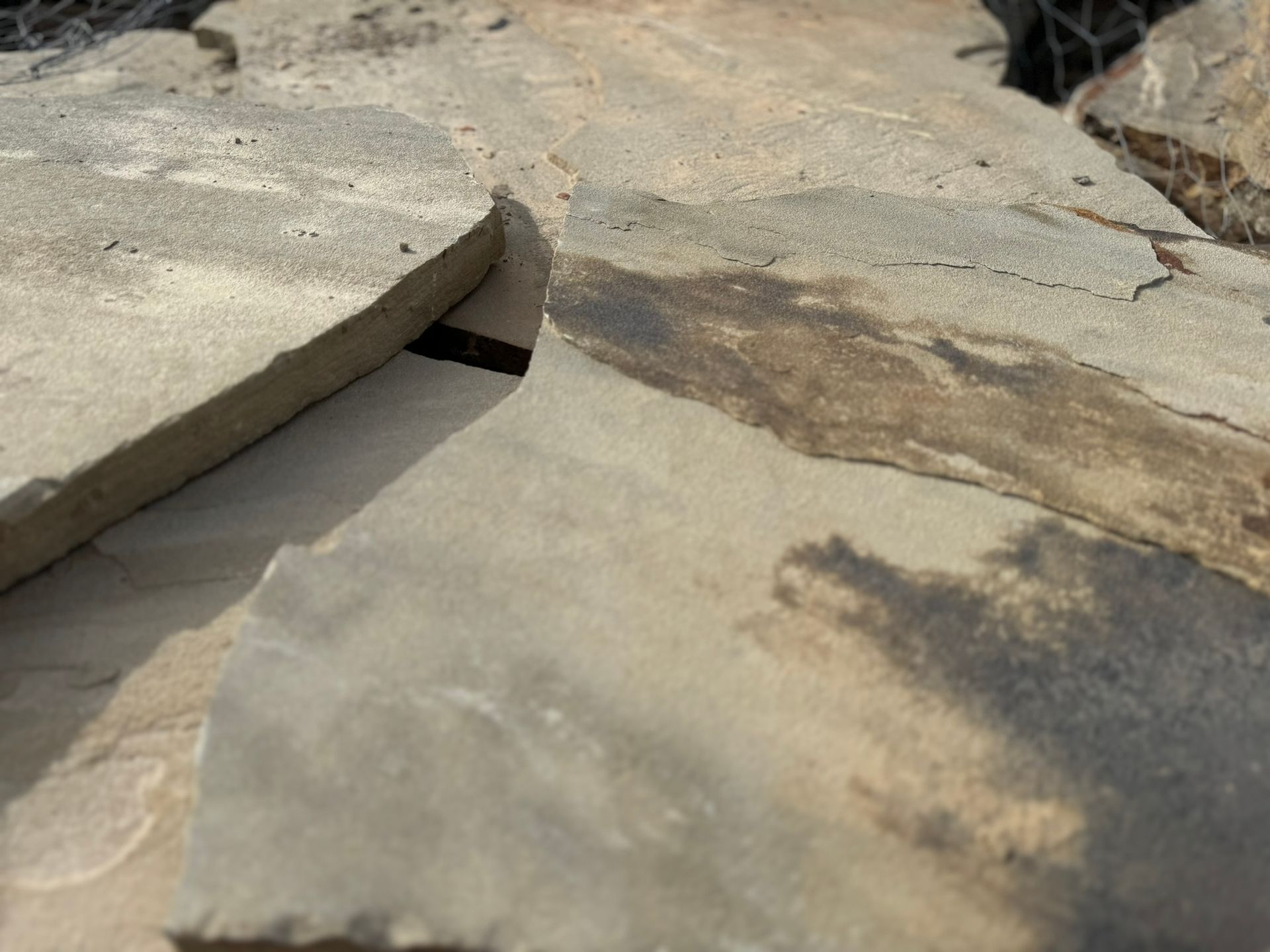 A pile of rocks sitting on top of each other on the ground.