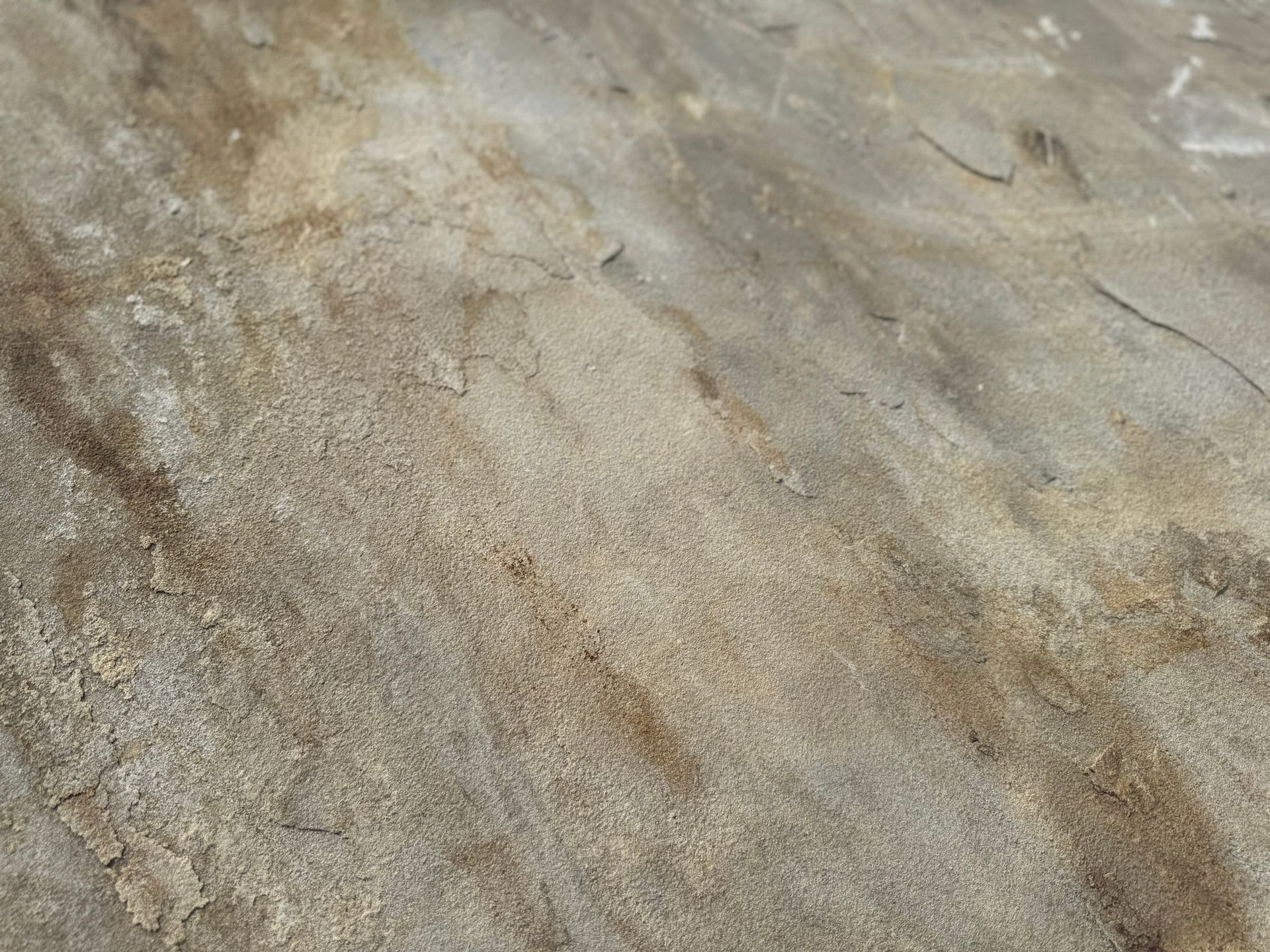 A close up of a sandy surface with a marble texture.