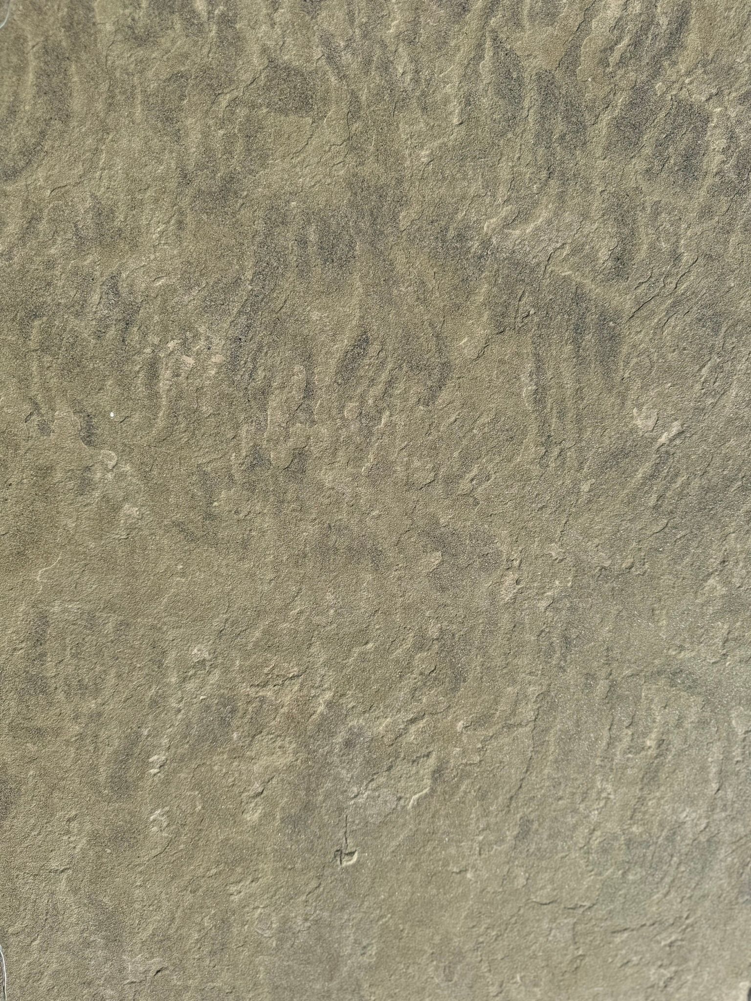 A close up of a concrete surface with a grainy texture.