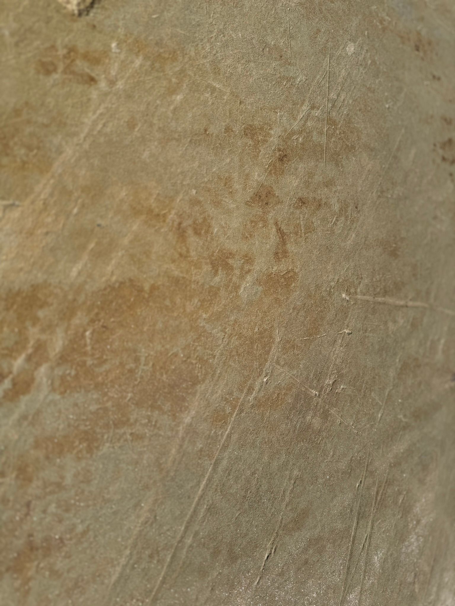 A close up of a concrete surface with a lot of scratches on it.