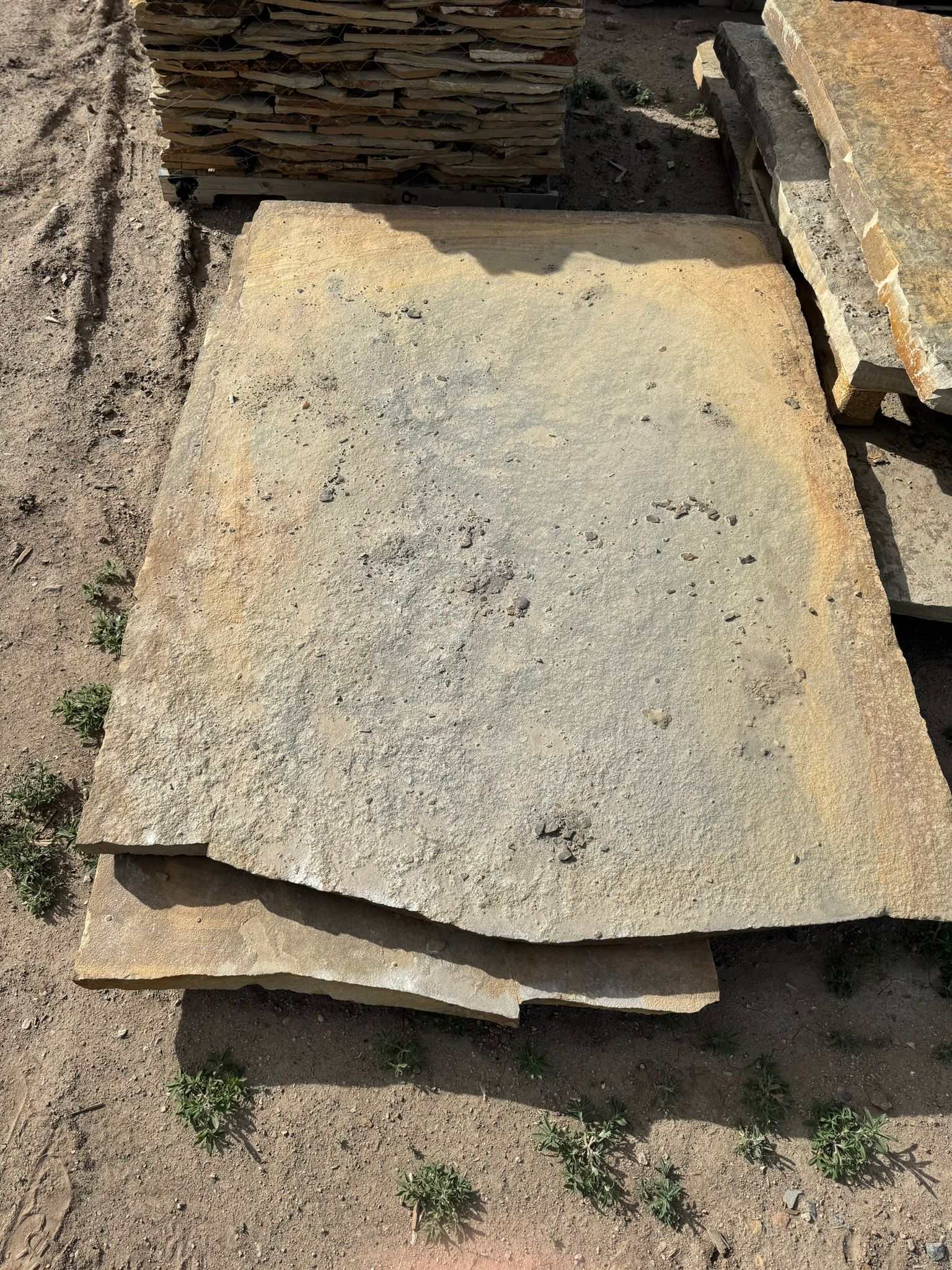 A pile of rocks sitting on top of each other on the ground.