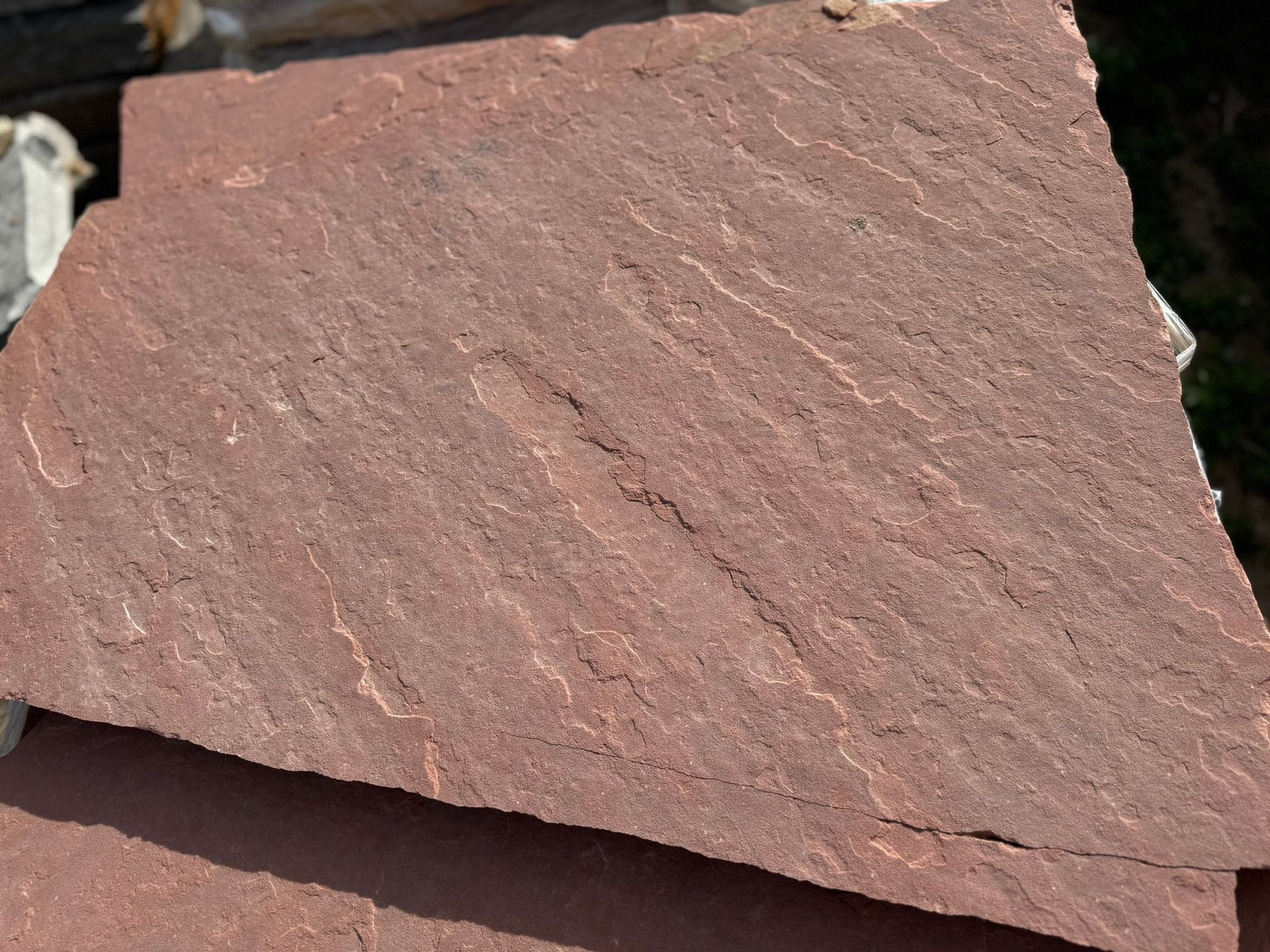 A close up of a piece of red stone