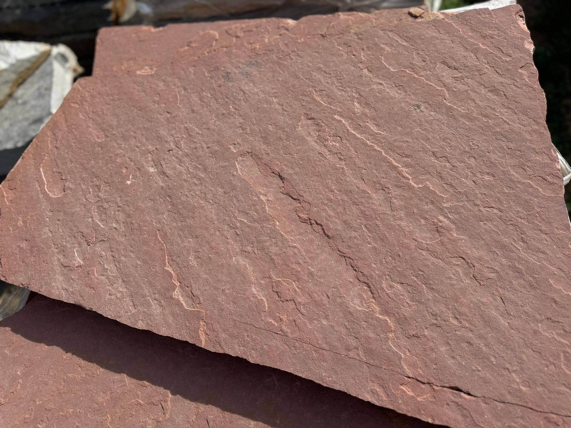 A close up of a pile of red rocks