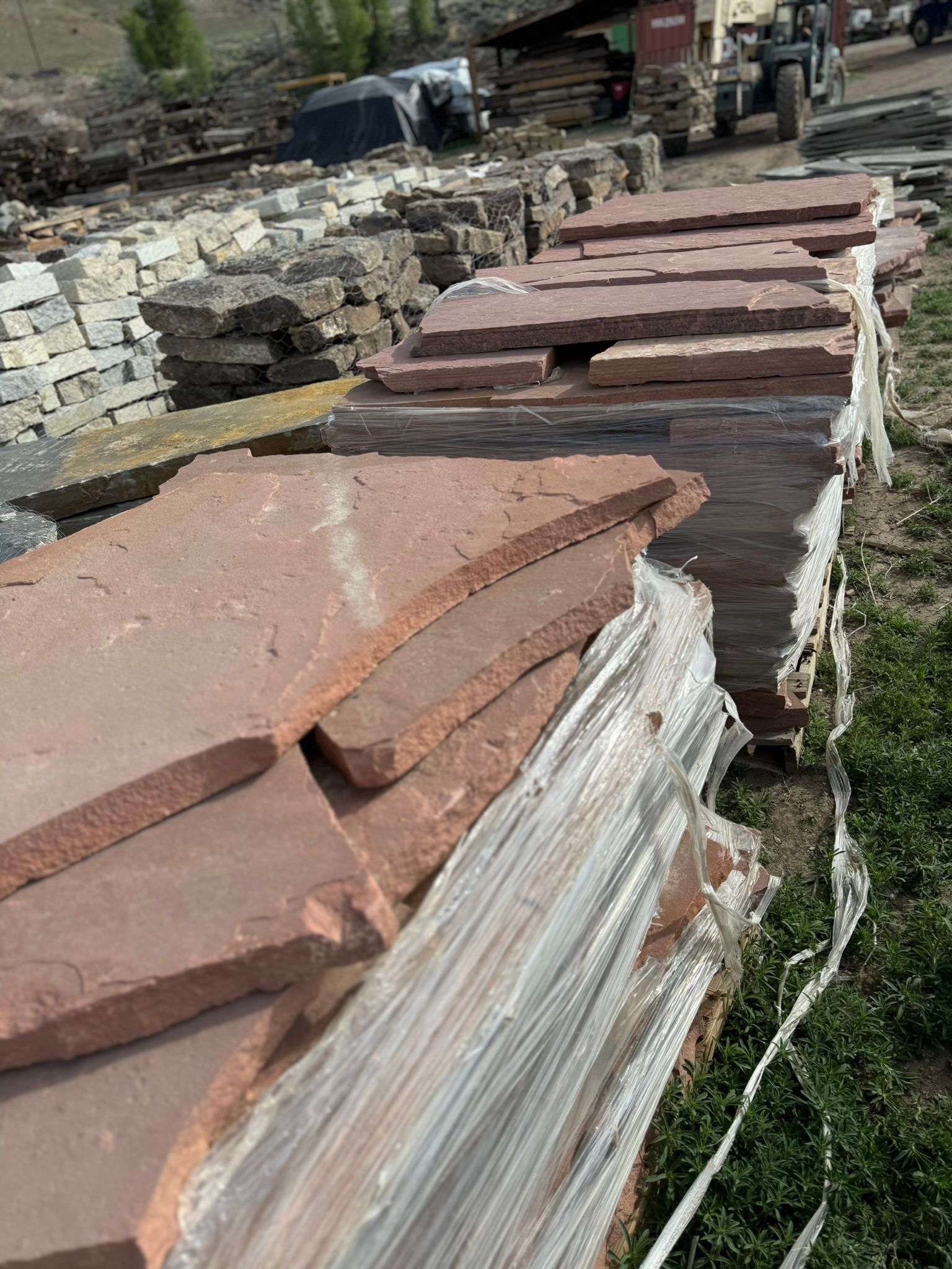 A pile of rocks sitting on top of each other in a field.