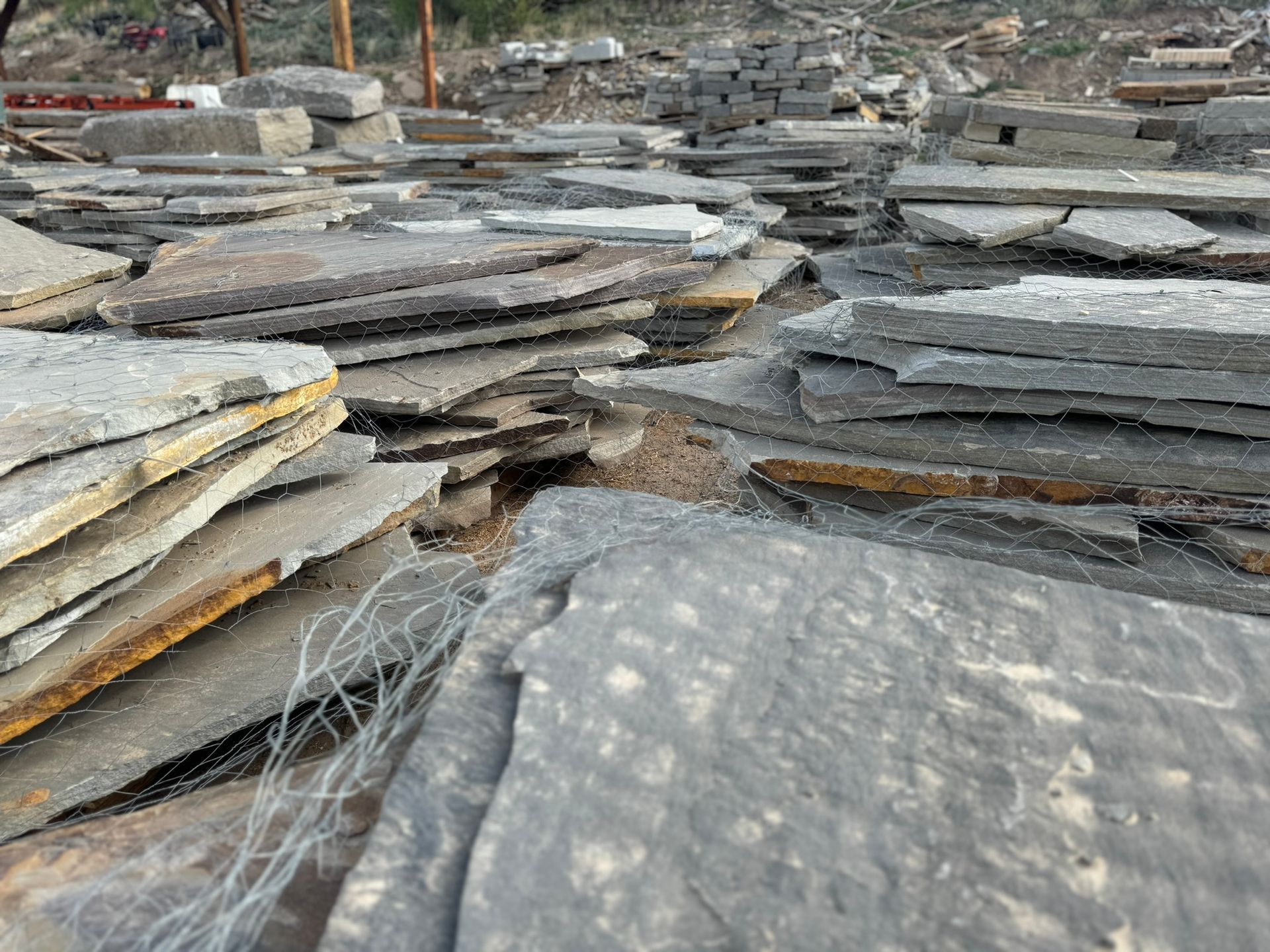A pile of rocks sitting on top of each other in a field.