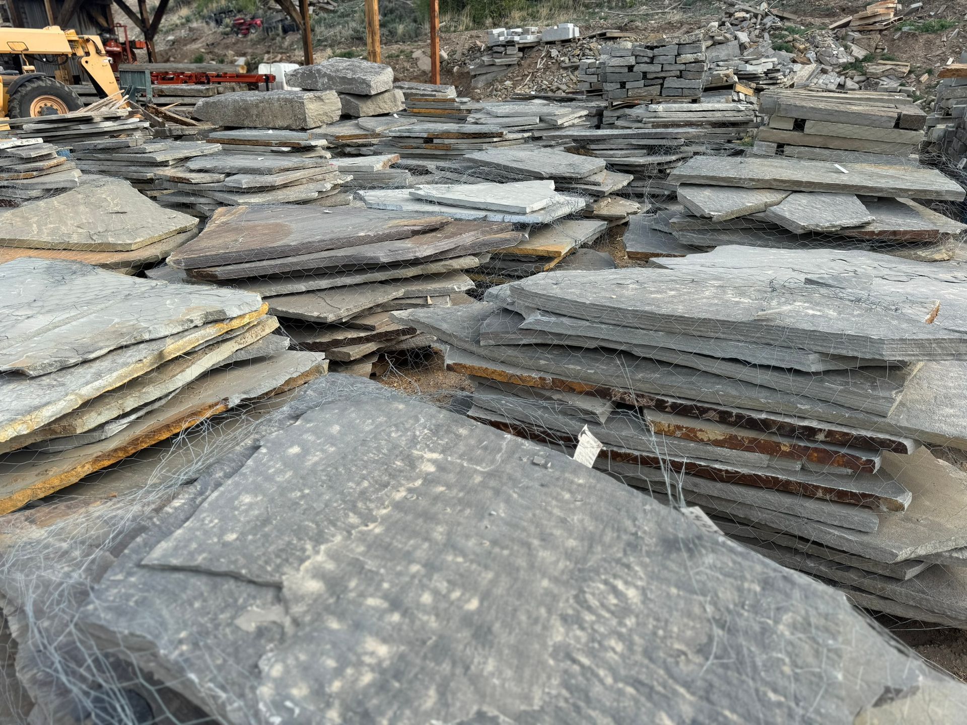 A pile of rocks sitting on top of each other in a field.