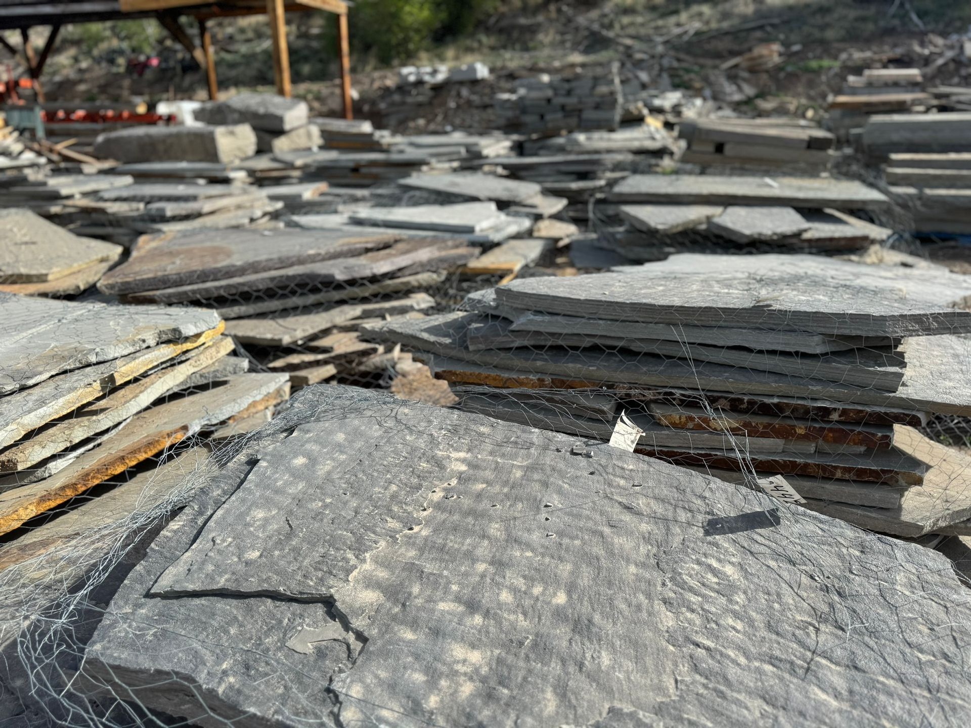 A pile of rocks sitting on top of each other in a field.