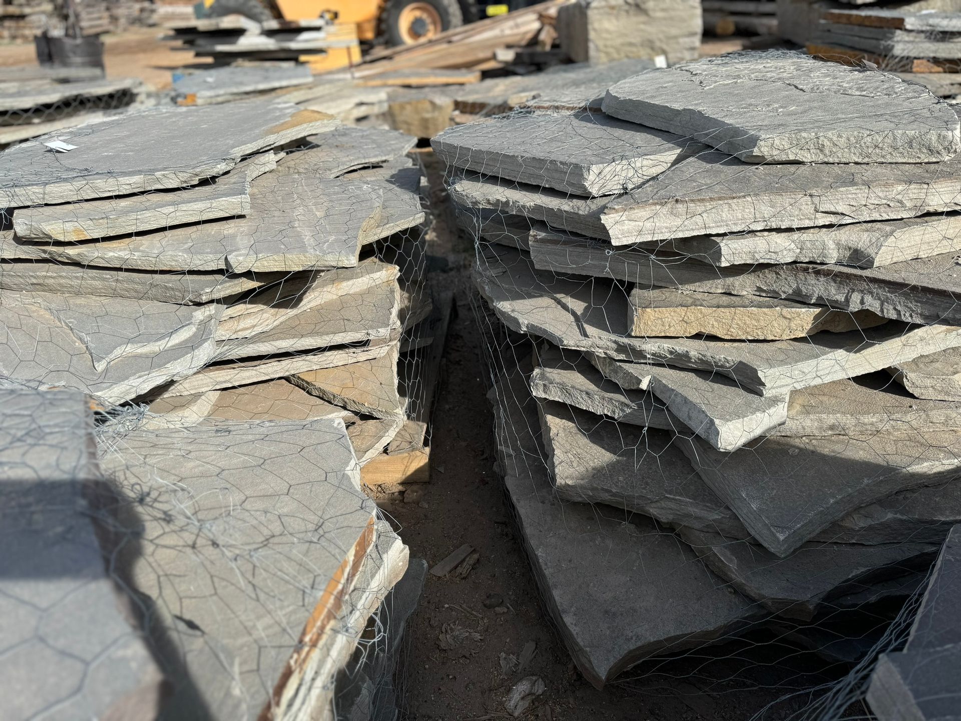 A pile of rocks is sitting on top of each other on the ground.