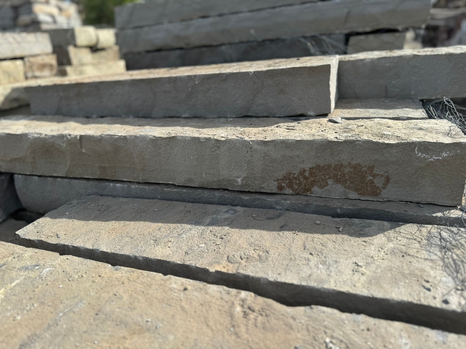 A pile of bricks stacked on top of each other on a concrete surface.