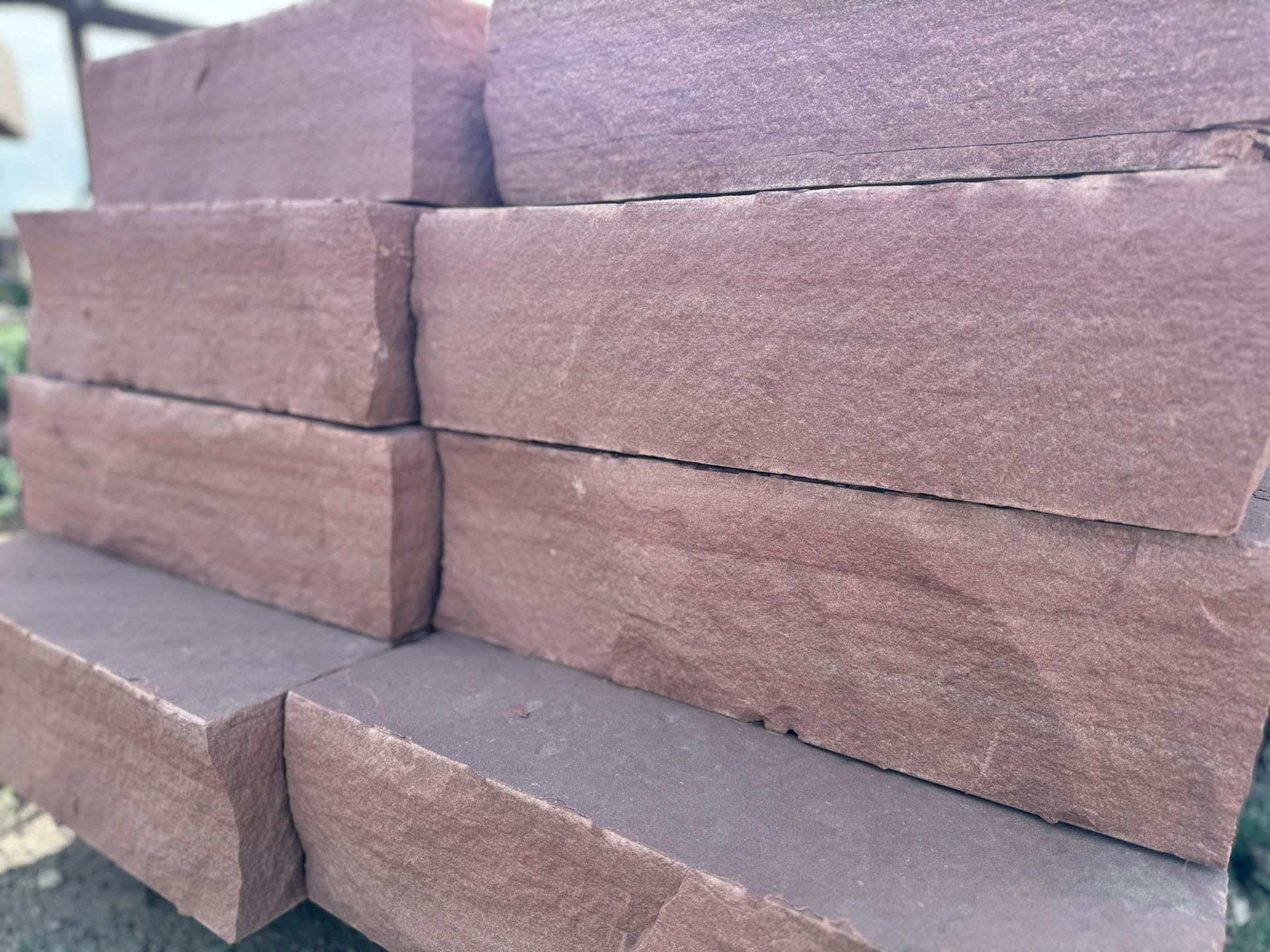 A pile of red bricks stacked on top of each other.