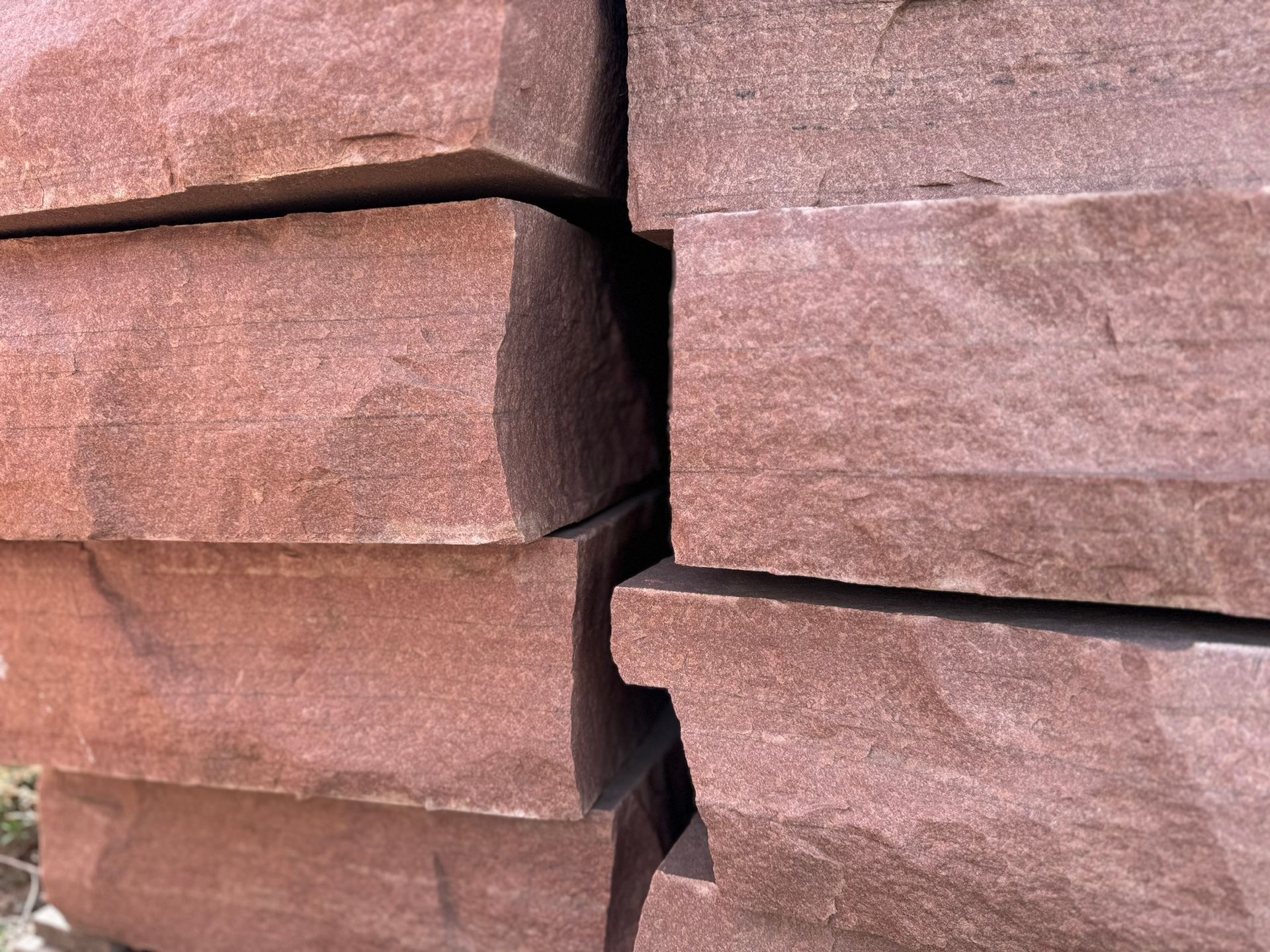 A pile of red bricks stacked on top of each other.