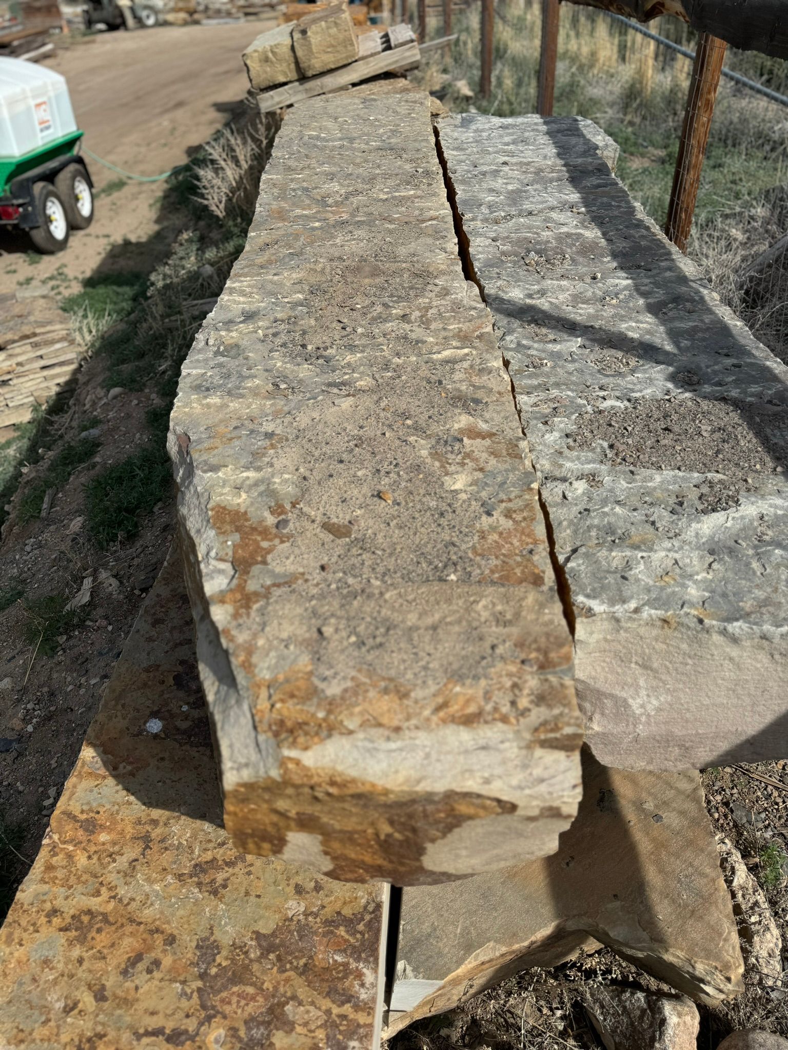 A large piece of rock is sitting on top of a pile of rocks.