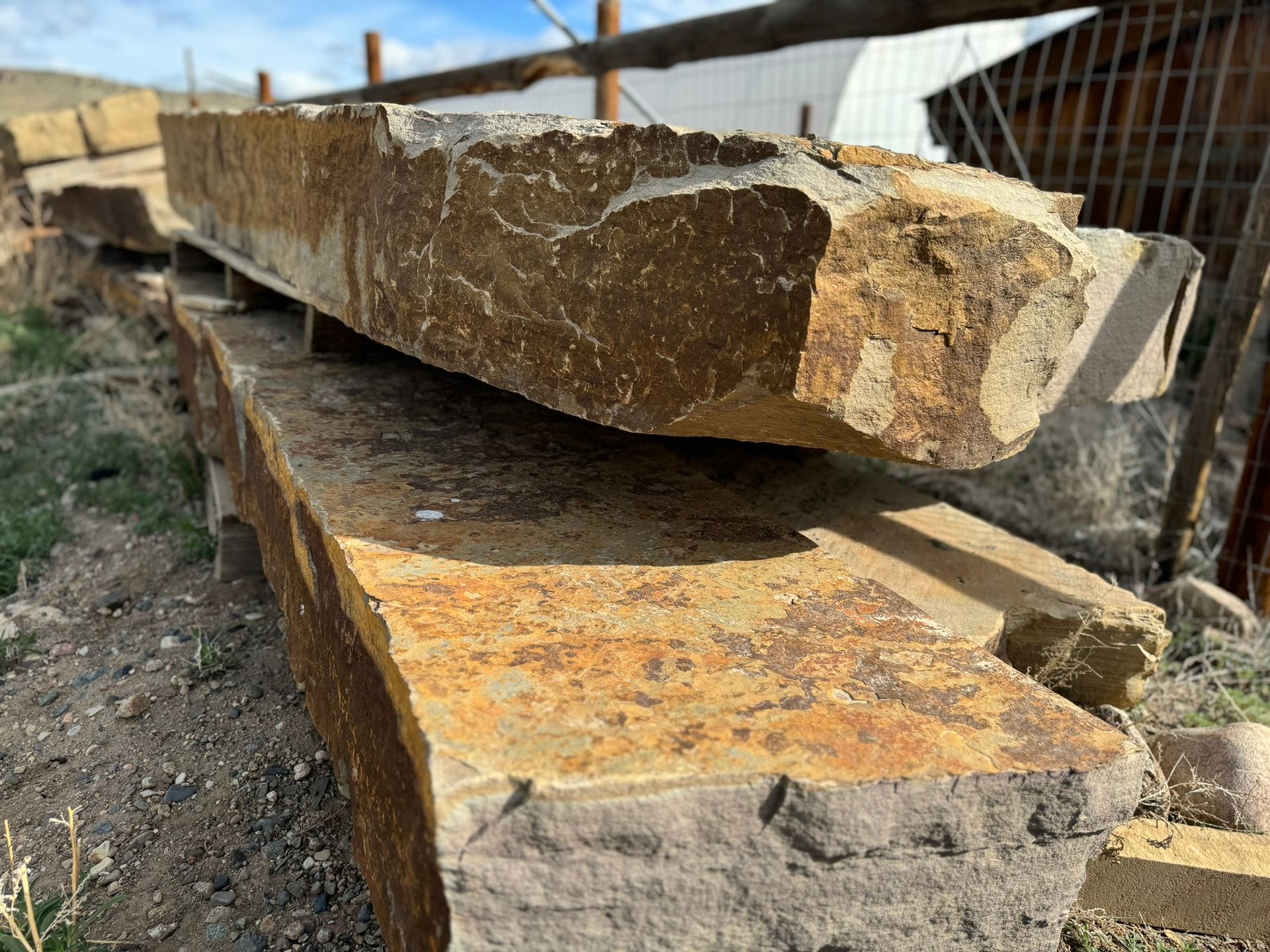 A pile of rocks sitting on top of each other on the ground.