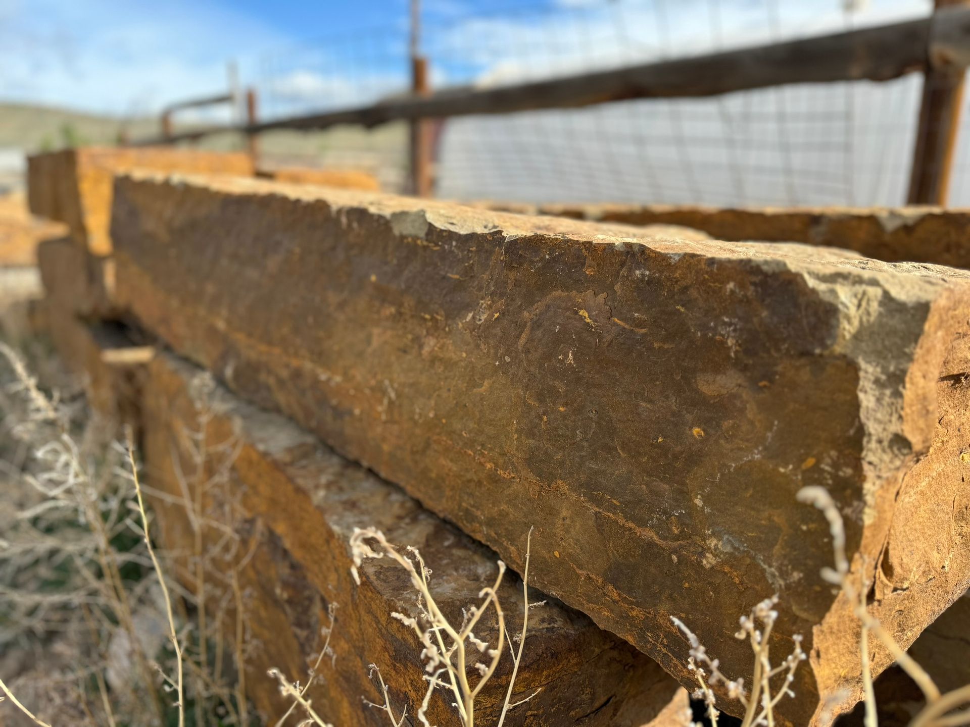 A pile of rocks sitting on top of each other in a field.