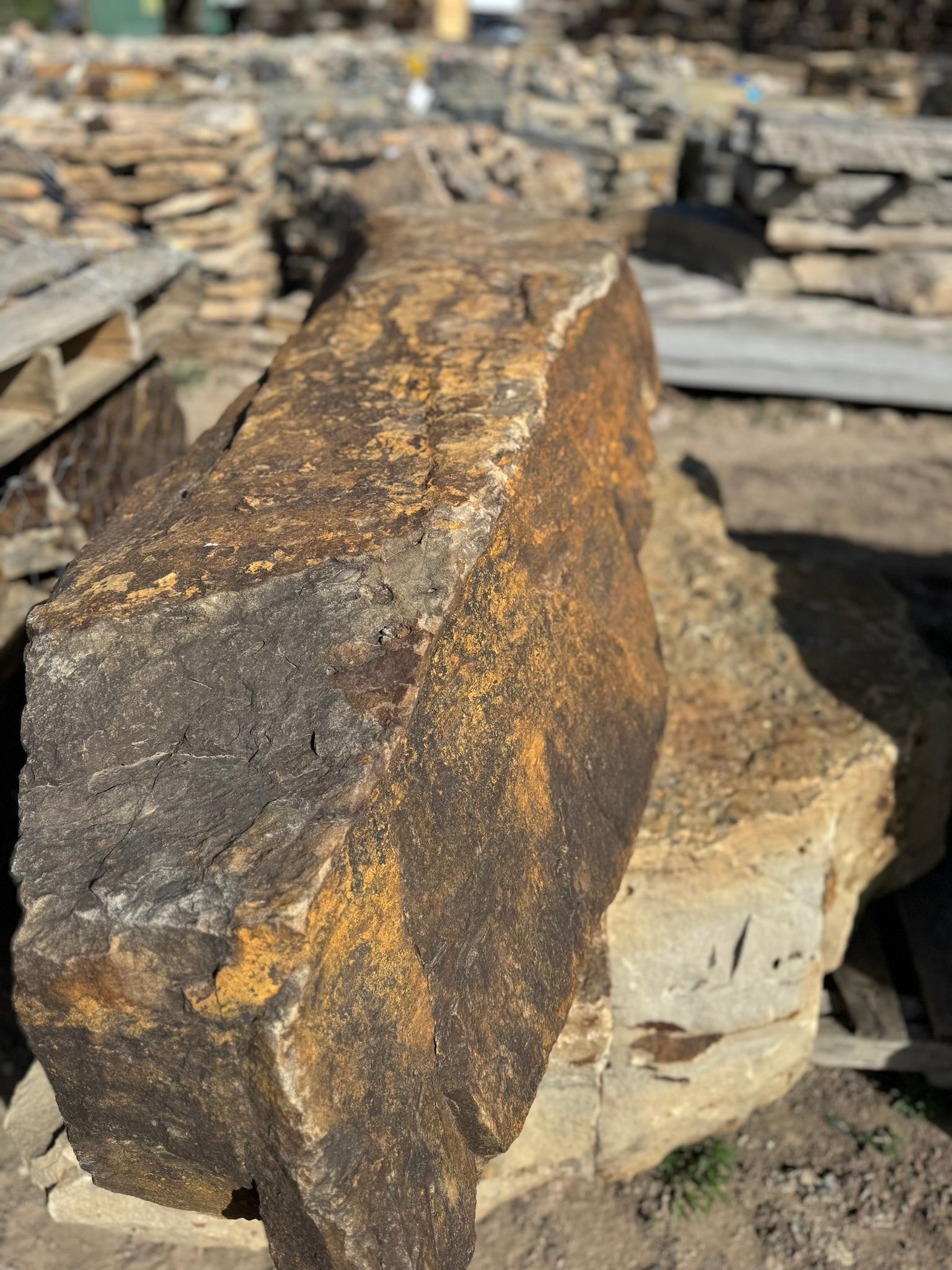 A large rock is sitting on top of a pile of rocks.