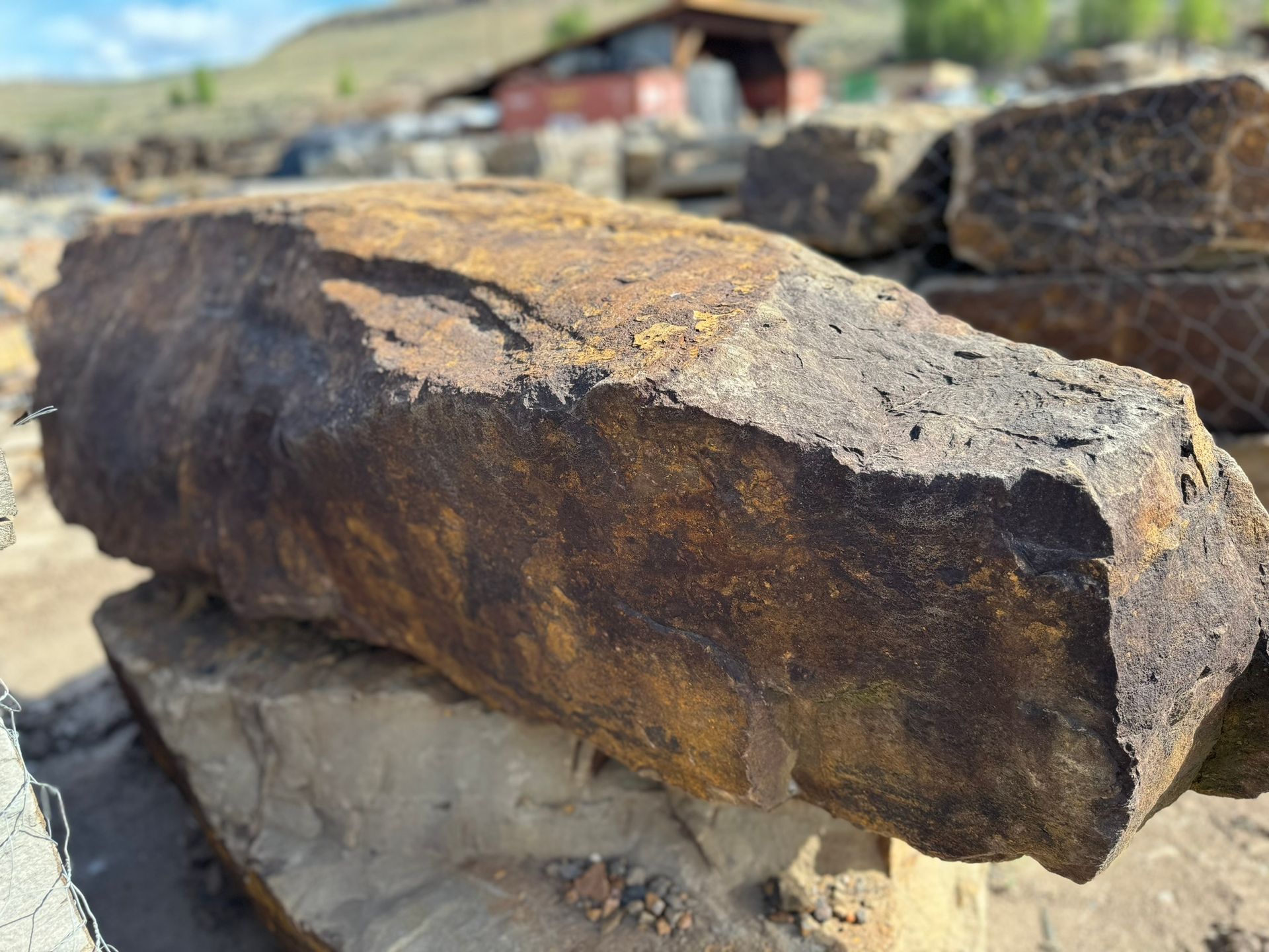 A large rock is sitting on top of a pile of rocks.