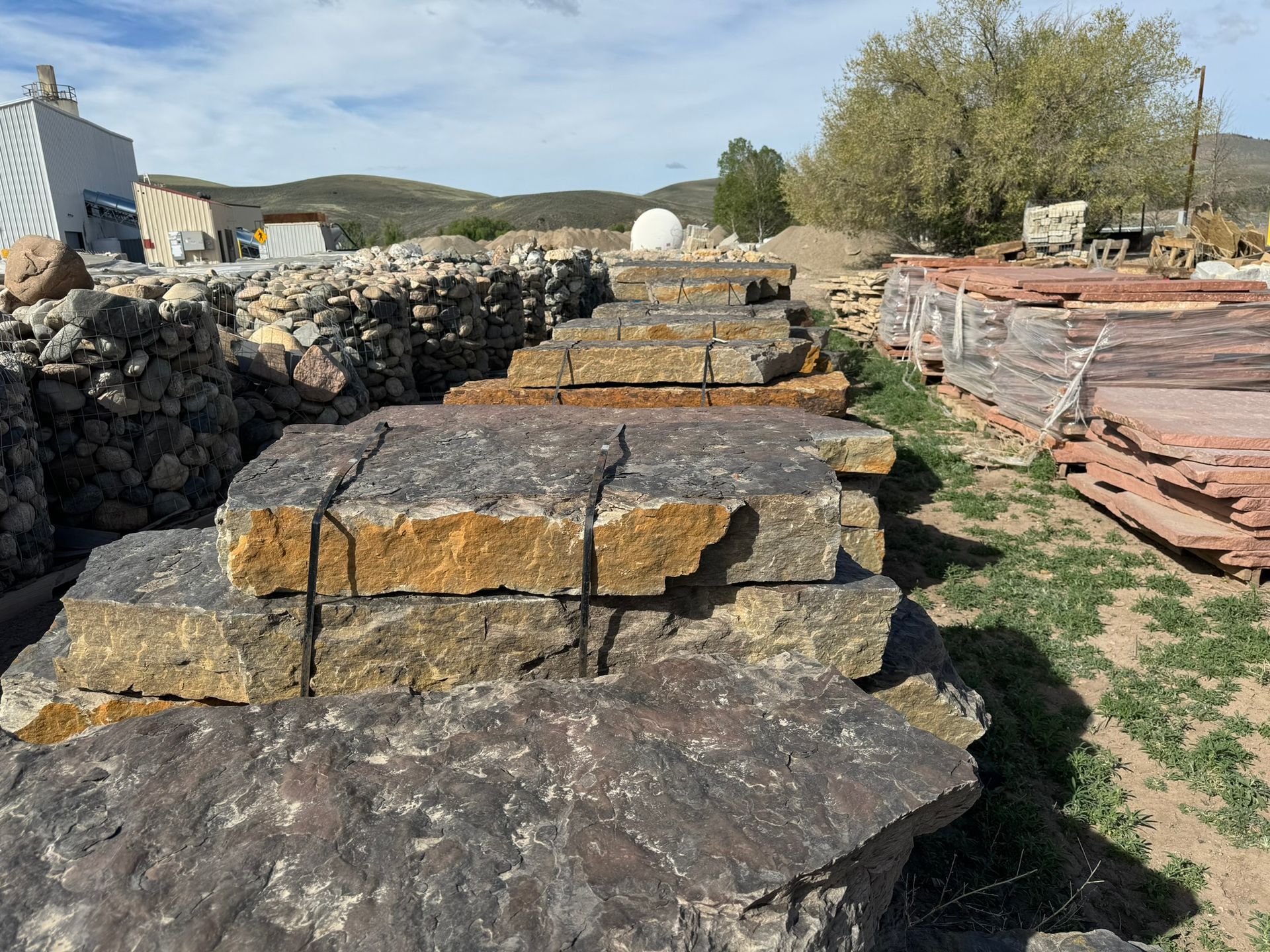 A pile of rocks sitting on top of each other in a field.
