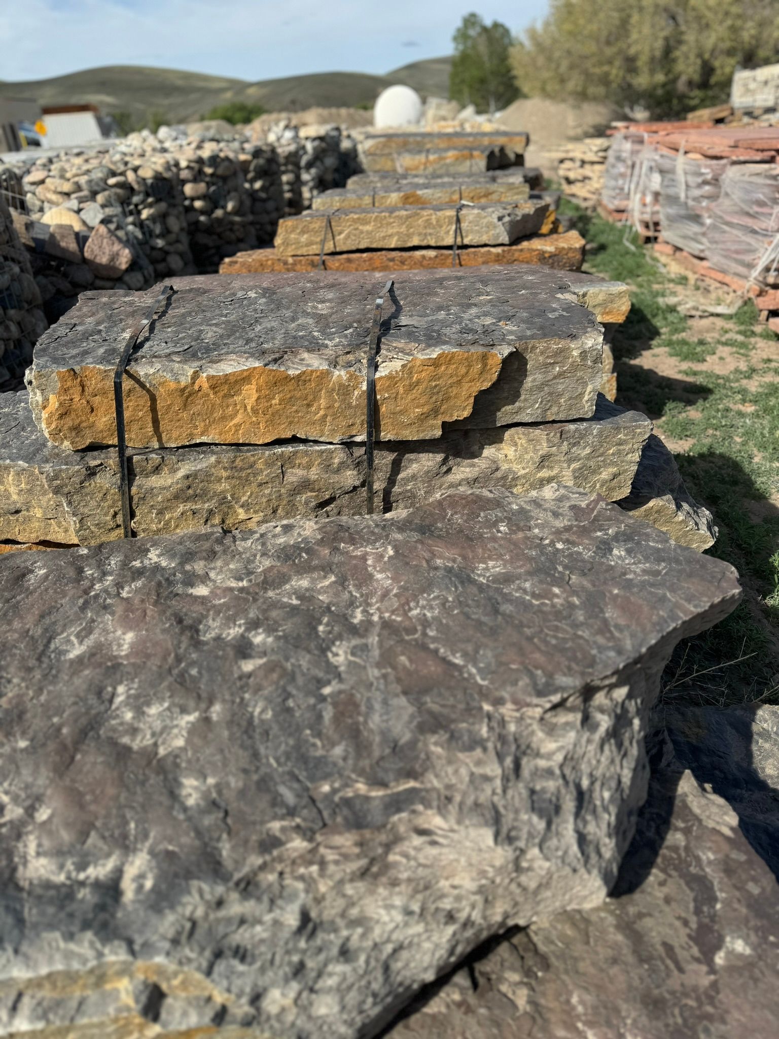 A pile of rocks sitting on top of each other in a field.