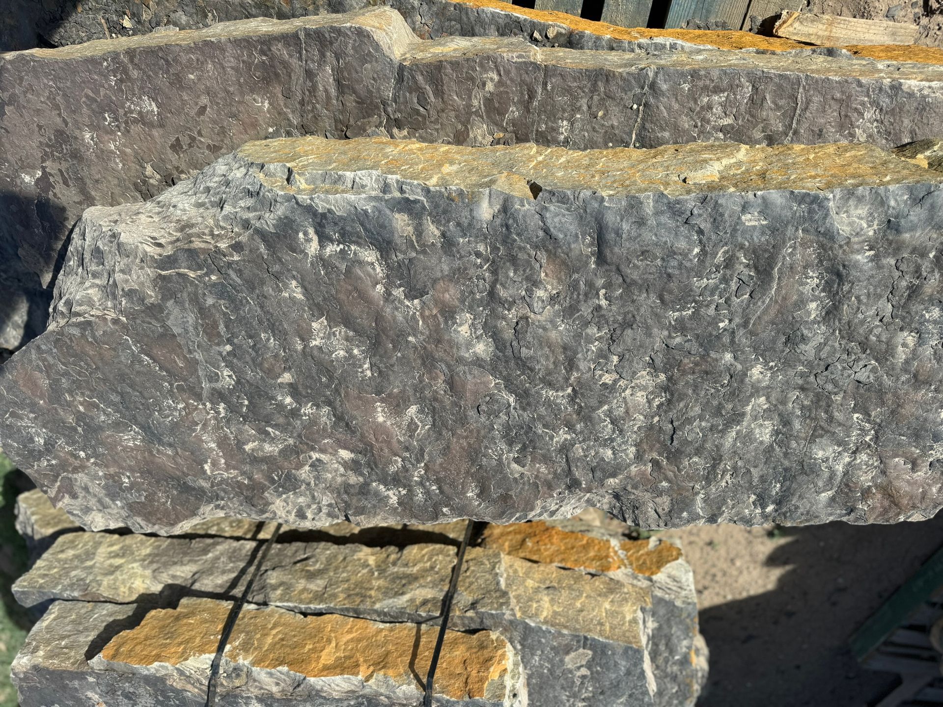 A pile of rocks sitting on top of each other on the ground.