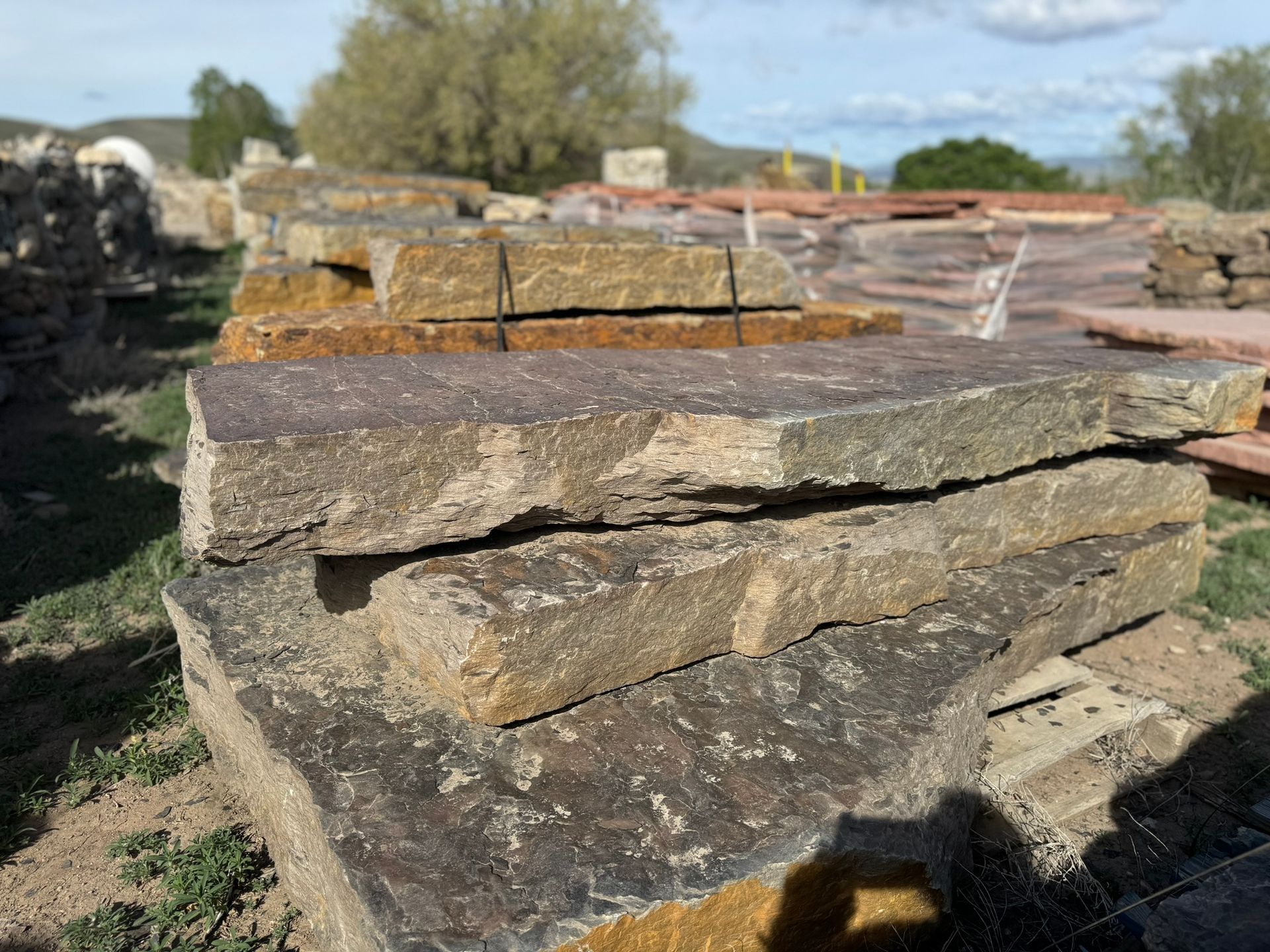 A pile of rocks sitting on top of each other in a field.