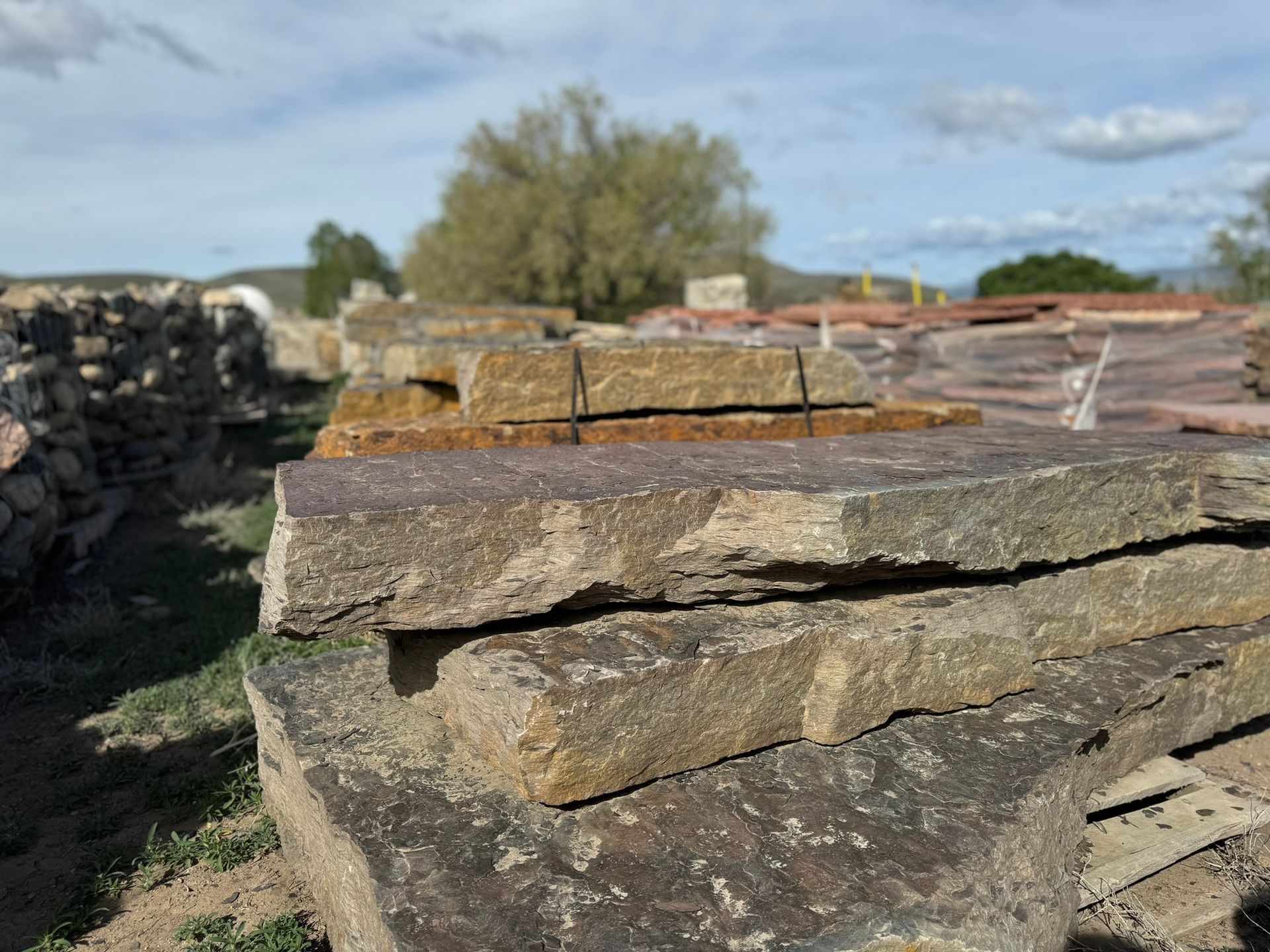 A pile of rocks sitting on top of each other in a field.