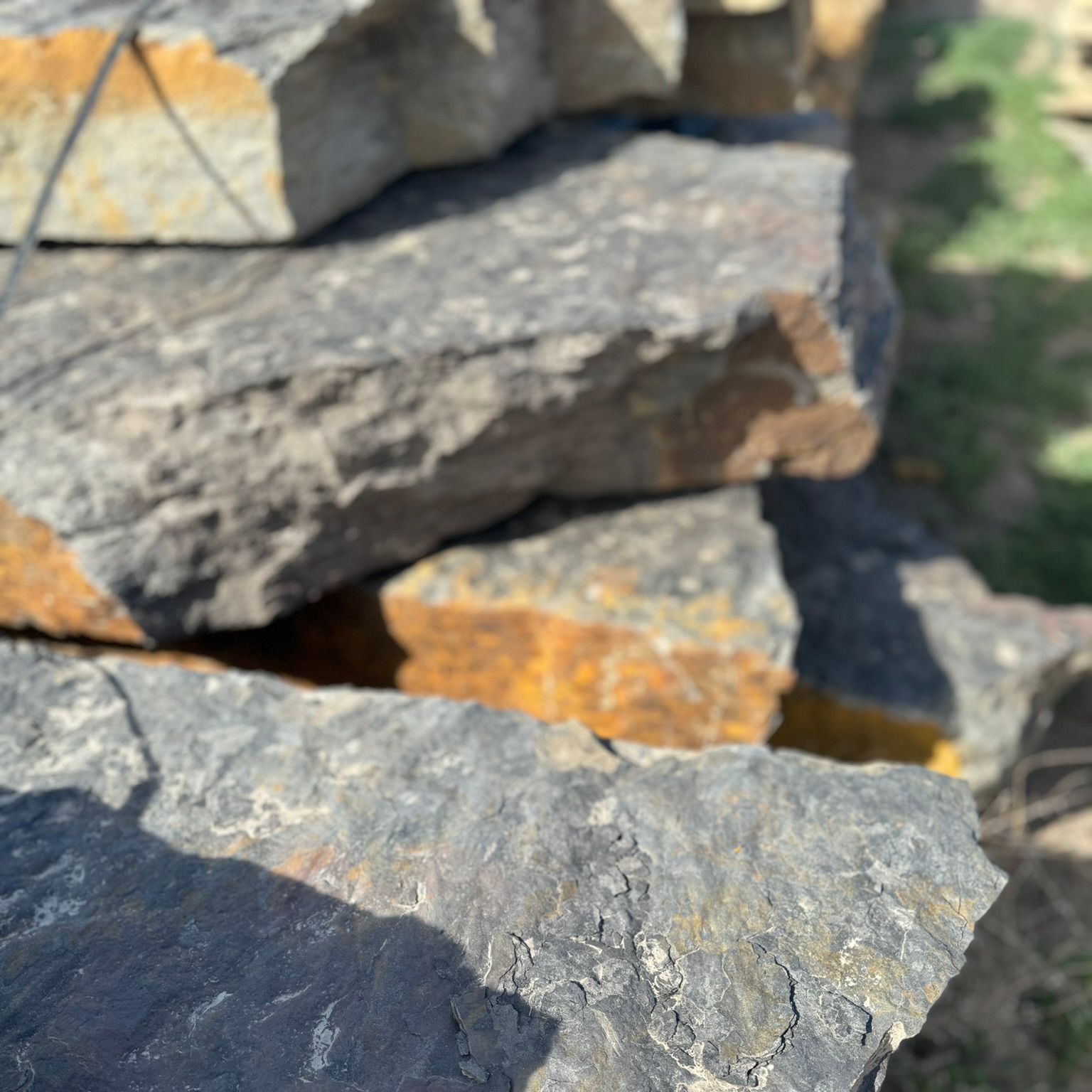 A pile of rocks stacked on top of each other in a field.