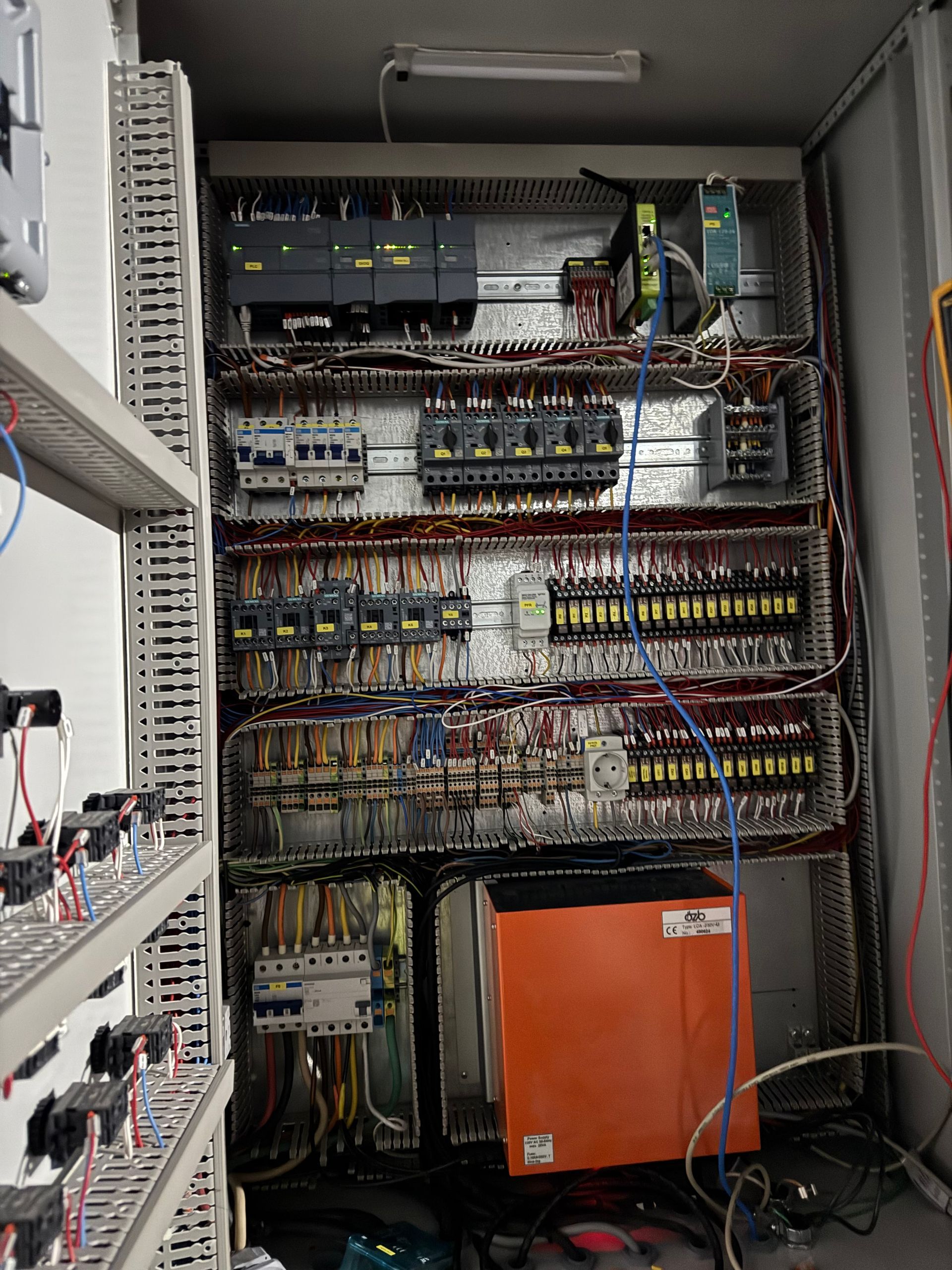 Orange generator with exposed engine components. Black frame, various tubes and wires.