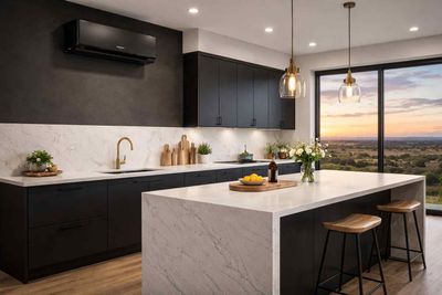 Interconnected silver spiral metal HVAC ducts suspended from a ceiling under a skylight.