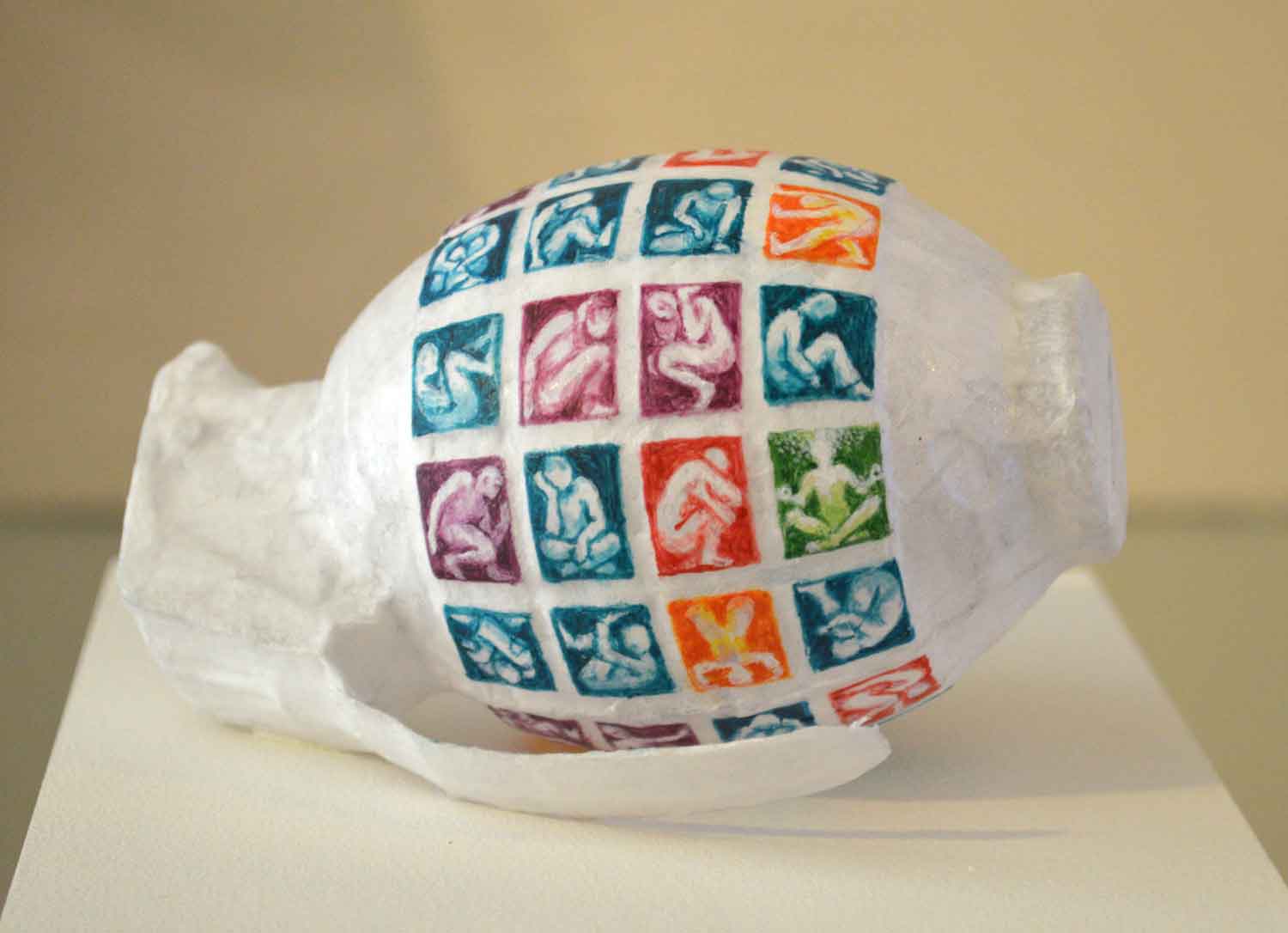 A 3d fine artwork of a grenade painted with tiny people in boxes by artist Evelyn Sinclair, based in Kendal, Cumbria in the Lake District.