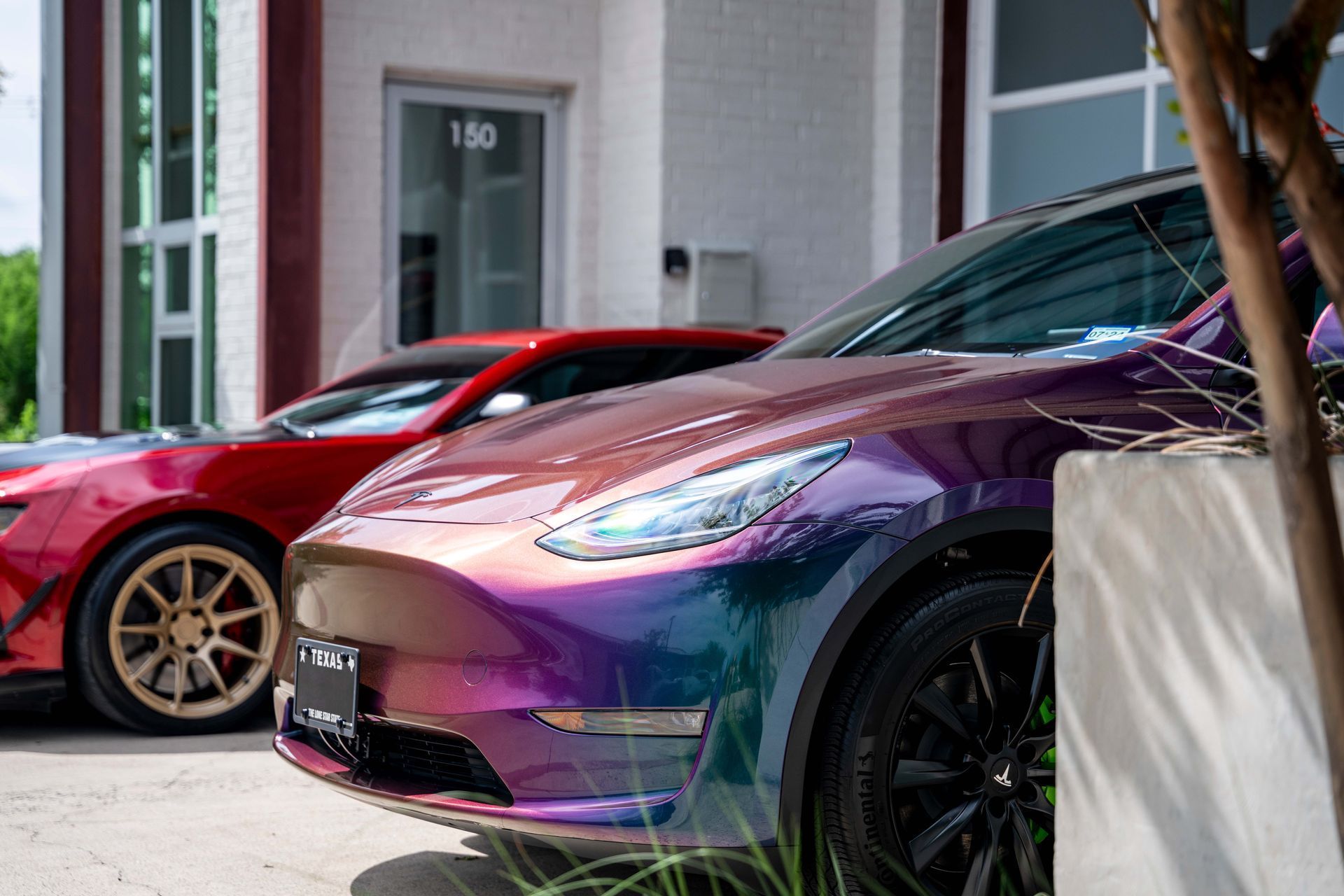 A row of cars parked in front of a building.